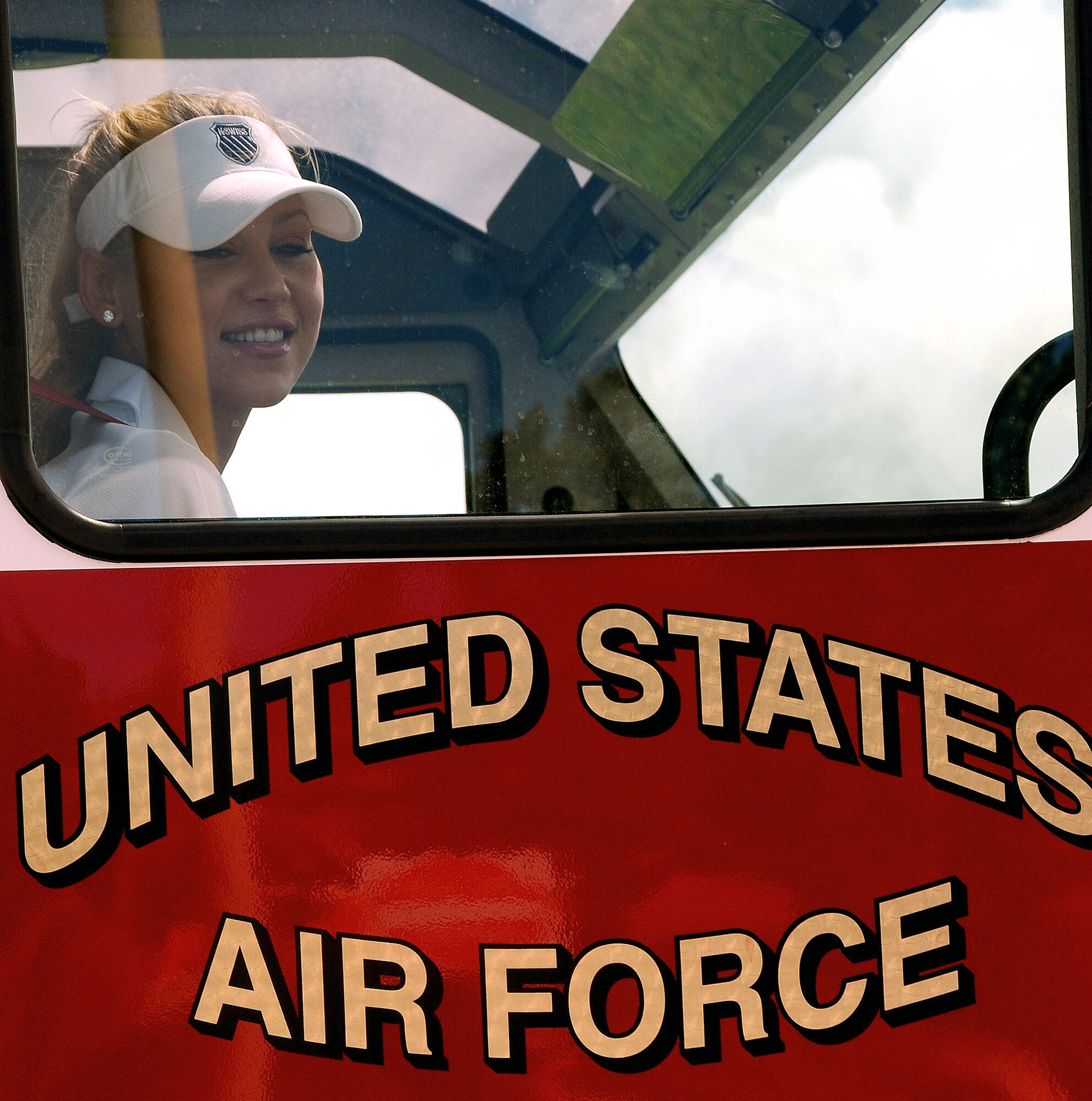 Anna Kournikova receives a ride in a firetruck from the Fire and Emergency Services Flight Oct. 29 at Andersen Air Force Base, Guam. Her tour was sponsored by the USO to boost morale of the military members on Guam. (U.S. Air Force photo/Airman 1st Class Courtney Witt) 
