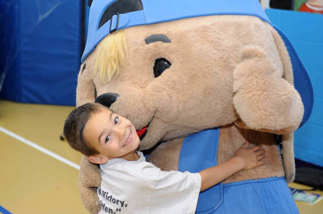 Brenden Lindgren receives a hug for participating in a contest with Sammy Rabbit here, Oct. 30. Sam Renick, author of the book, “It's A Habit, Sammy Rabbit!” visited Ellsworth to teach children how to be financially responsible. (U.S. Air Force photo/Airman 1st Class Adam Grant)
