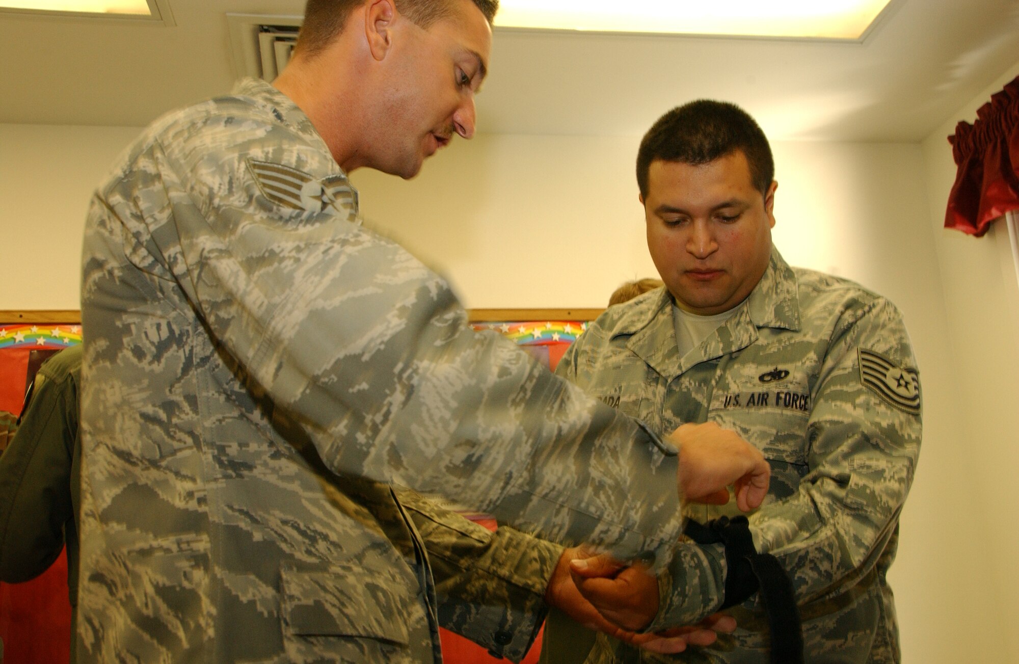 Staff Sgt. Jeremy York, 71st Flying Training Wing self-aid and buddy care advisor, assists Tech. Sgt. Aaron Estrada, 71st Communications Squadron, on learning to stop bleeding during Team Vance's SABC Rodeo Oct. 31 at the Community Chapel Activities Center. With five 90-minute courses throughout the day, the Rodeo gave the 71st MDG the opportunity to instruct more than 300 Airmen. (U.S. Air Force photo by Staff Sgt. Brian Hill)