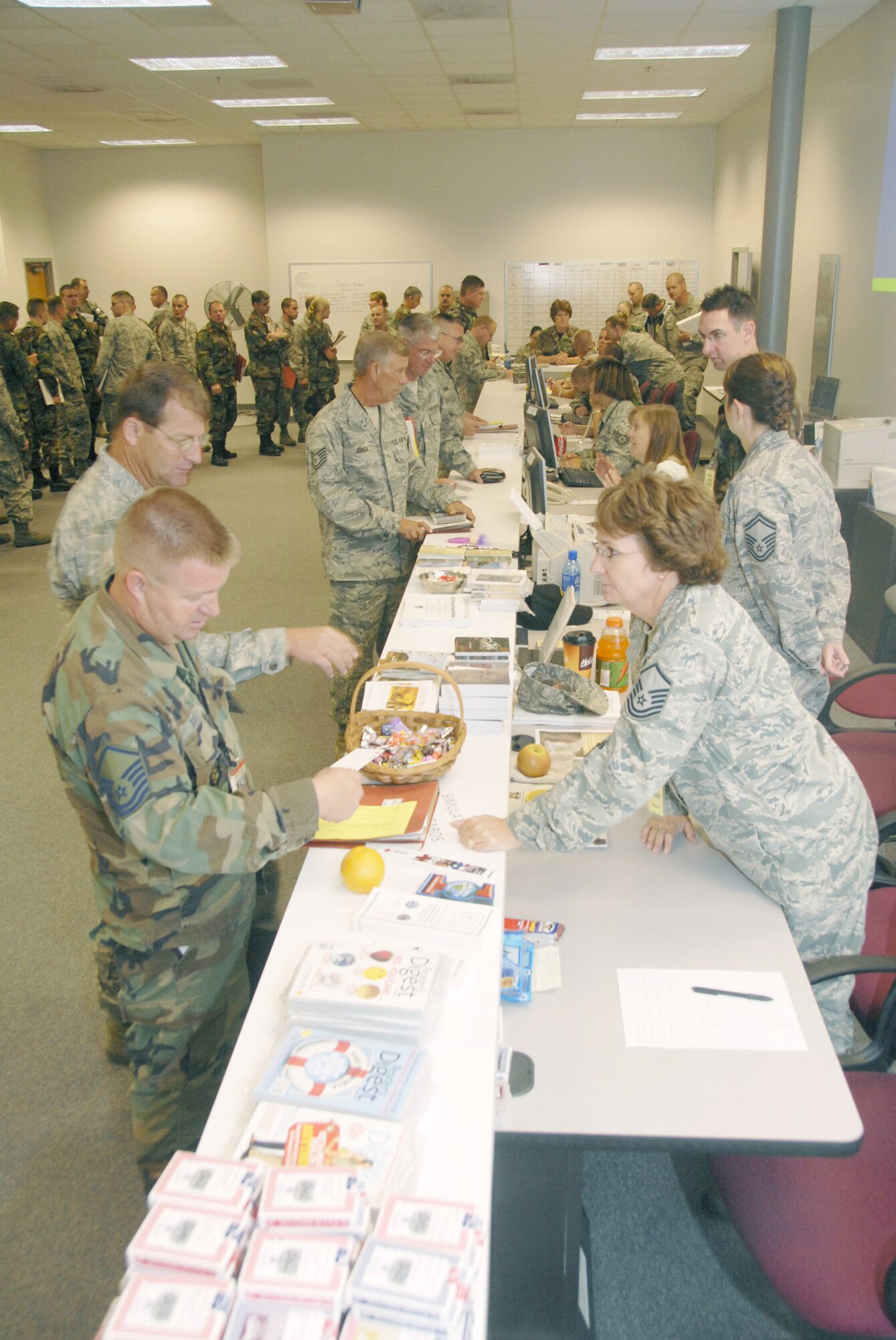 Master Sgt. Bob Boye, 442nd Aircraft Maintenance Squadron , left, settles some last minute business with the 442nd Fighter Wing?s Airman and Family Readiness chief, Master Sgt. Vickie Chambers, prior to ?deploying? Oct. 4. The 442nd FW is an Air Force Reserve Command unit based at Whiteman Air Force Base, Mo.  (U.S. Air Force photo/Master Sgt. Bill Huntington)