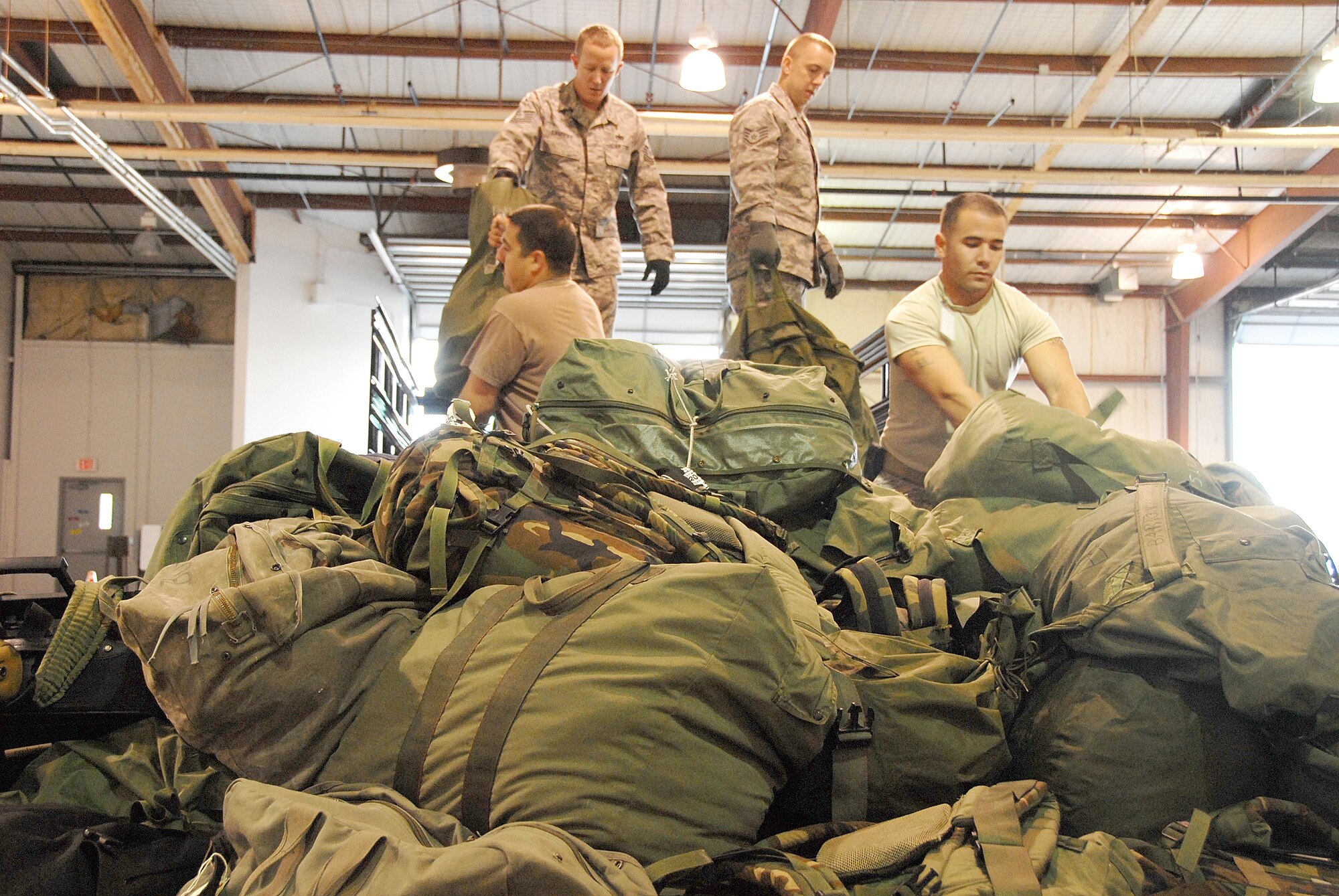 Supporting the 44nd Fighter Wing?s Operational Readiness Exercise, Oct. 4, a team of Airmen from the 509th Bomb Wing, unloads a truck-load of baggage onto a waiting cargo palette to be weighed. The 509th BW is an active-duty unit and the 442nd FW is an Air Force Reserve unit.  Both are based at Whiteman Air Force Base, Mo.  (U.S. Air Force photo/Staff Sgt. Kent Kagarise)