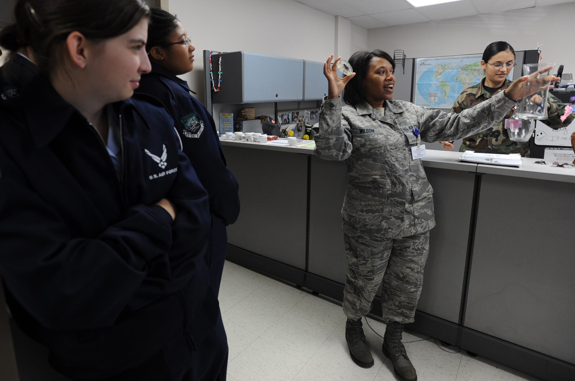 Senior Airman Tamara Wilson talks to Air Force Junior Reserve Officer Training Corps cadets about spiders and other critters monitored by the public health office at McConnell Air Force Base, Kan. The Derby High School cadets visited the base on Oct. 30 and were welcomed by Airmen from the 931st Air Refueling Group and the 22nd Air Refueling Wing. Airman Wilson is a Reserve public health technician assigned to the 931st Aerospace Medicine Flight. Airman 1st Class Susan Mitchell (also pictured) was one of several 22nd Airmen who helped Wison's presentation. The 931st is an associate Air Force Reserve Command unit and the 22nd is its active-duty host at McConnell. (U.S. Air Force photo/Tech. Sgt. Jason Schaap)