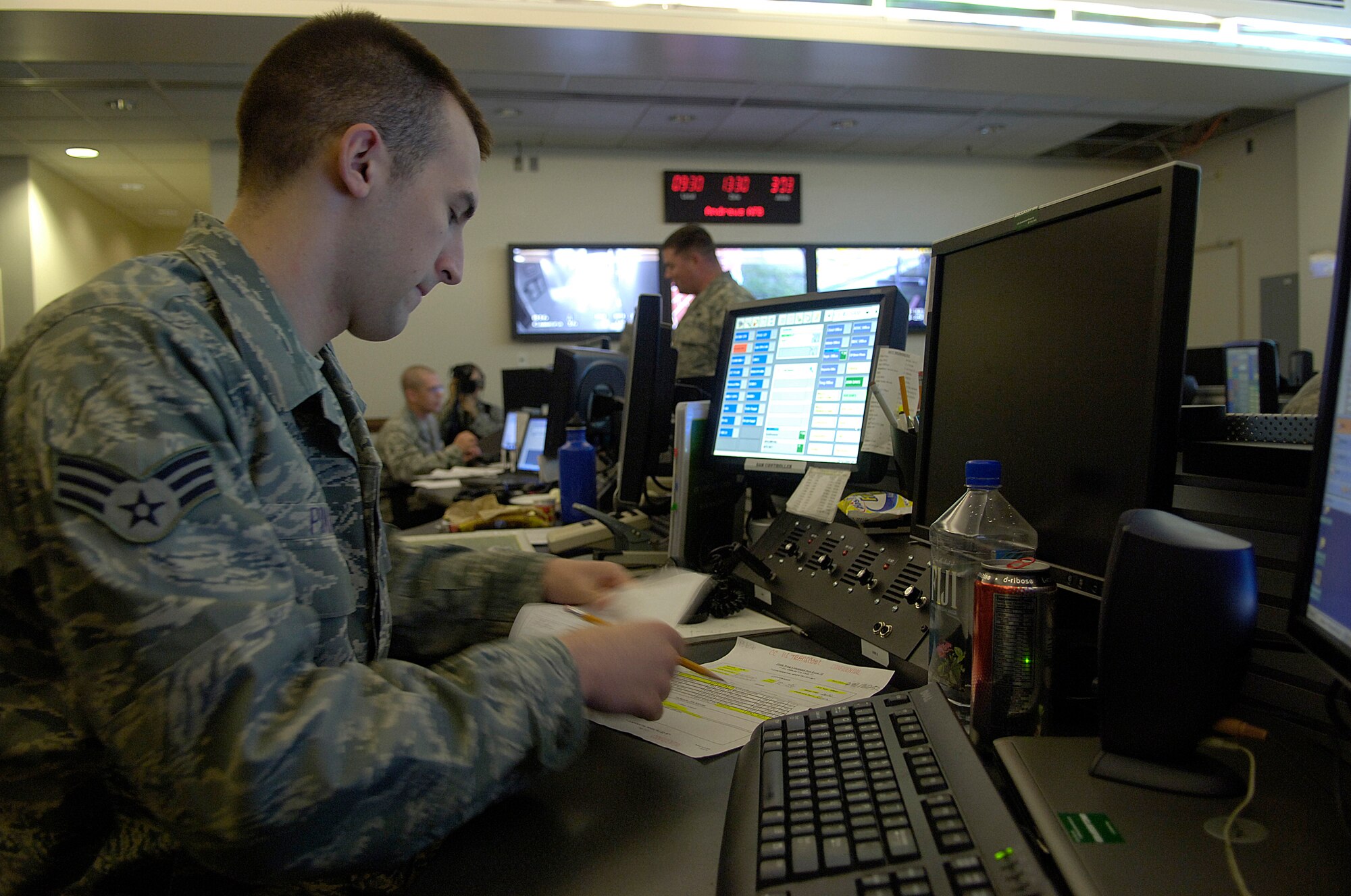 Senior Airman Joseph Pinard, 316th Wing command post controller, sorts through paperwork at the command post during the Capital Shield 09 exercise Oct. 29 on Andrews. The command post serves as a central focal point for information for the base during attacks, in flight emergencies, and ground emergencies. The exercise consisted of multiple scenarios including suspicious packages, mass casualty training, and terrorist attack procedures. Capital Shield is an annual exercise in the National Capital Region involving civilian and military authorities such as 316th Wing, 779th Medical Group, 89th Airlift Wing, Prince George’s County Fire and Police Departments and Maryland State Police. (U.S. Air Force photo by Senior Airman Renae Kleckner)