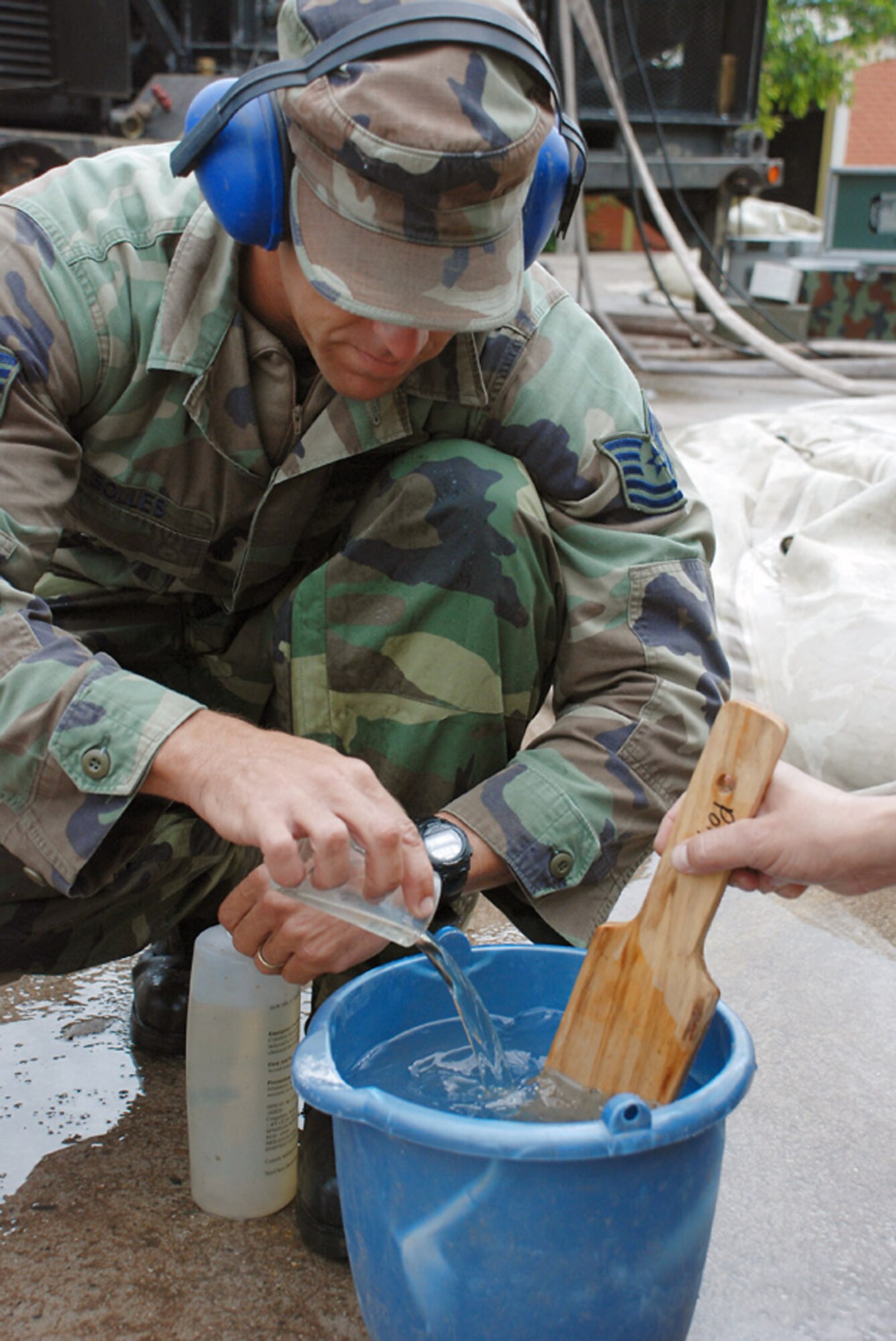 Tech. Sgt. Shane Bolles works on purifying the well water Oct. 29 at La Paz, Honduras. After only a few days, the servicemembers have purified more than 2,500 gallons of drinking water from the flood affected community. Sergeant Bolles is assigned to Soto Cano Air Base, Honduras, deployed from Dyess Air Force Base, Texas.(U.S. Army photo/Spc. Ethan Anderson)