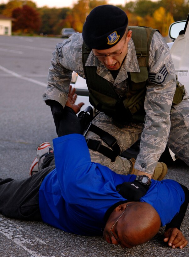 Staff Sgt. Brian Hennen, 316th Security Forces patrolman, detains a suspect after he and other suspects attempted to bring weapons onto base during the Capital Shield Exercise Oct. 27.  Scenarios like this help to train security forces so they are prepared in the event of a real world situation. The exercise consisted of multiple scenarios including suspicious packages, mass casualty training, and terrorist attack procedures. Capital Shield is an annual exercise in the National Capital Region involving civilian and military authorities such as 316th Wing, 779th Medical Group, 89th Airlift Wing, Prince George’s County Fire and Police Departments and Maryland State Police. (U.S. Air Force photo by Senior Airman Steven Doty)