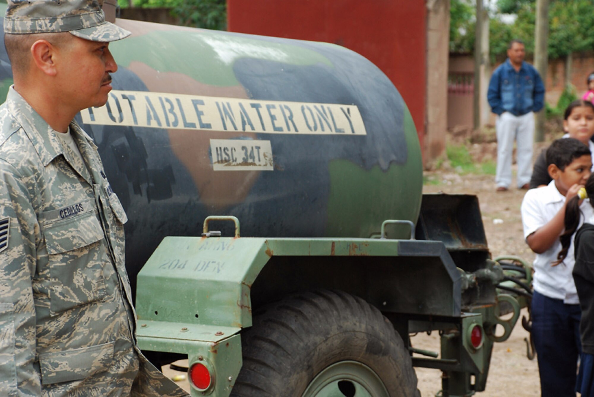 Tech. Sgt. Ramano Cedillos assists people in getting clean water Oct. 29 at La Paz, Honduras. After the water is filtered, it is placed in 500-gallon water buffalos so people have free access to the purified water. Sergeant Cedillos is assigned to Soto Cano Air Base, Honduras, and deployed from the Phoenix Air National Guard in Arizona. (U.S. Army photo/Spc. Ethan Anderson)