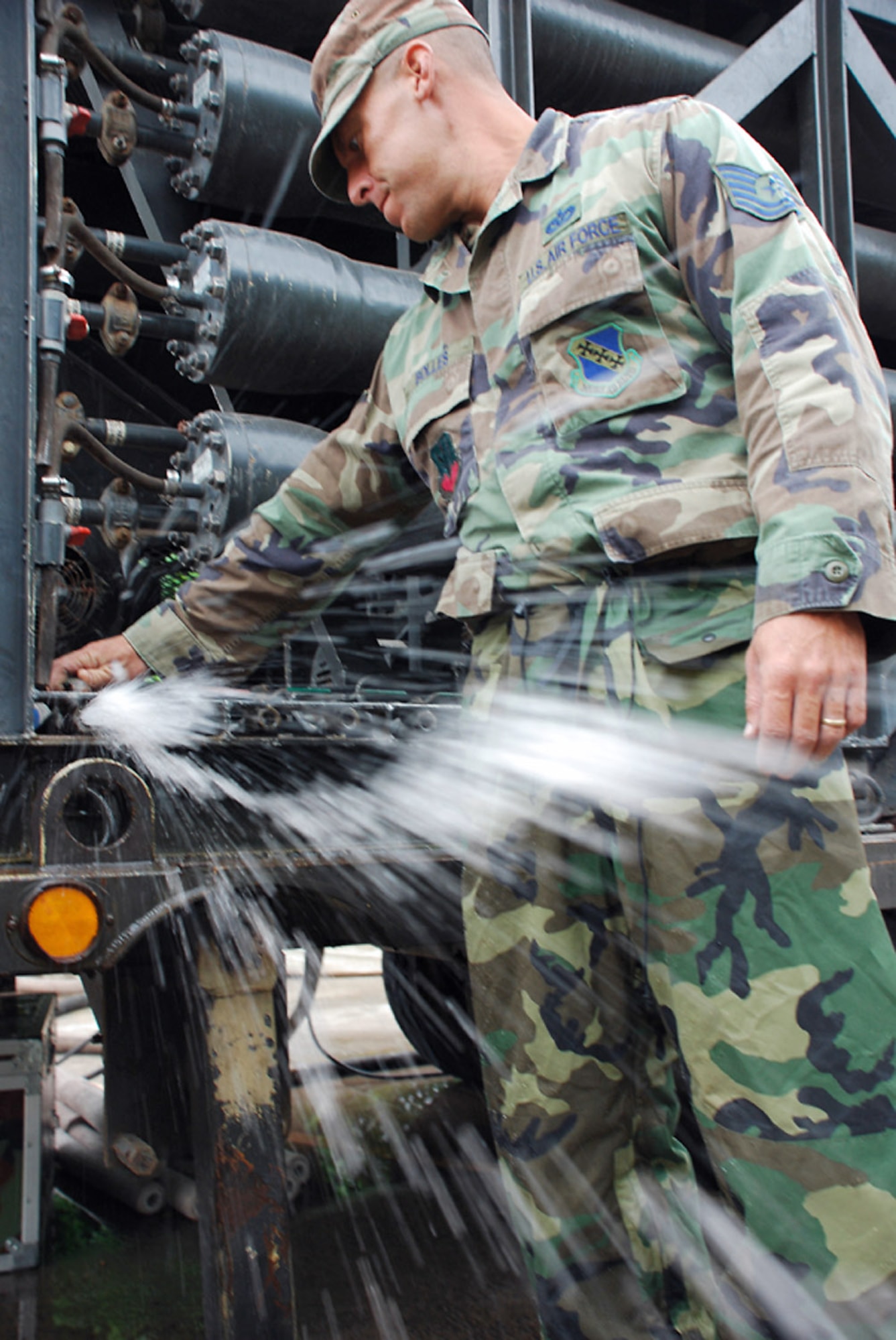 Tech. Sgt. Shane Bolles works on a water filtration machine Oct. 29 at La Paz, Honduras. Servicemembers from Joint Task Force-Bravo are participating in a 10-day operation in a nearby community to filter well water. The well water became undrinkable after more than a weeklong stretch of rain caused flooding in the area. Sergeant Bolles is assigned to Soto Cano Air Base, Honduras, deployed from Dyess Air Force Base, Texas. (U.S. Air Force photo/Staff Sgt. Joel Mease) 