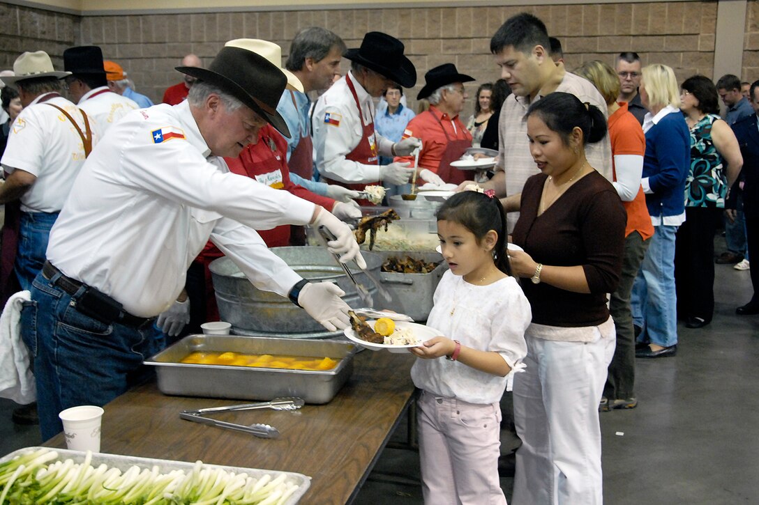 Members of the Mavericks serve a Texas style barbecue rib dinner to Sheppard families during the Military Family and Deployer Appreciation Dinner at the Multi Purpose Events Center Oct. 30. (U.S. Air Force photo/Mike Litteken)