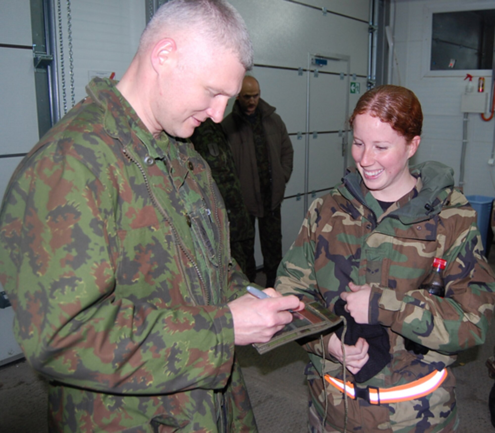 Airman 1st Class Evangeline Evanzia meets the Chief Enlisted Manager for Siauliai Air Base. Forty Lithuanian Senior NCO's visit the 493rd Expeditionary Fighter Squadron Oct. 29 at Siauliai Air Base, Lithuania. (U.S. Air Force photo by Master Sgt. Gregory Bianchi)