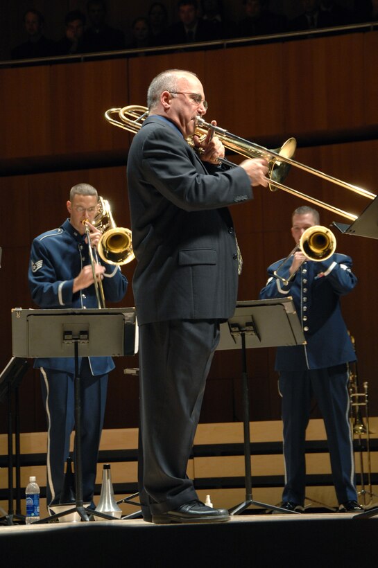 Mr. Joseph Alessi (front), principal trombonist with the New York Philharmonic, performed as a guest soloist with the USAF Brass in Blue on several pieces during 'Slides Across the Heartland' presented at the Holland Performing Arts Center on Monday, October 20, 2008.  Air Force trombonists pictured are Staff Sgt Matthew Erickson (left), Musical Director of the Brass in Blue and Staff Sgt Ben Kadow (right), principal trombone of the group.