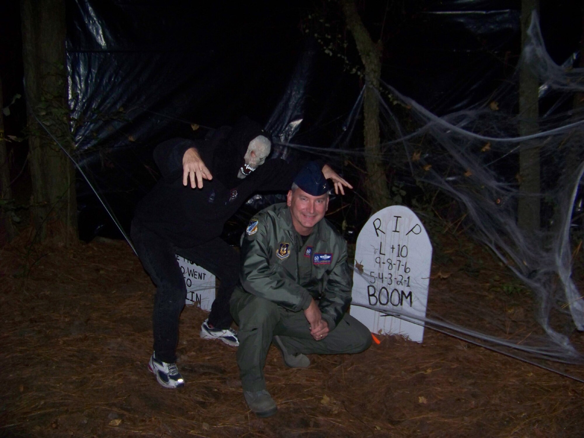 SEYMOUR JOHNSON AIR FORCE BASE, N.C. -- Col. Fritz Linsenmeyer, wing commander of the 916th Air Refueling Wing, gets spooked by one of the many volunteer goblins (Col. Caroline Evernham, 916th Operations Group commander) at the 916th Graveyard along the Seymour Johnson Haunted Trail on-base. The 4th Fighter Wing and 916th Air Refueling Wing teamed up to offer a scary experience for on-base trick-or-treaters last night.