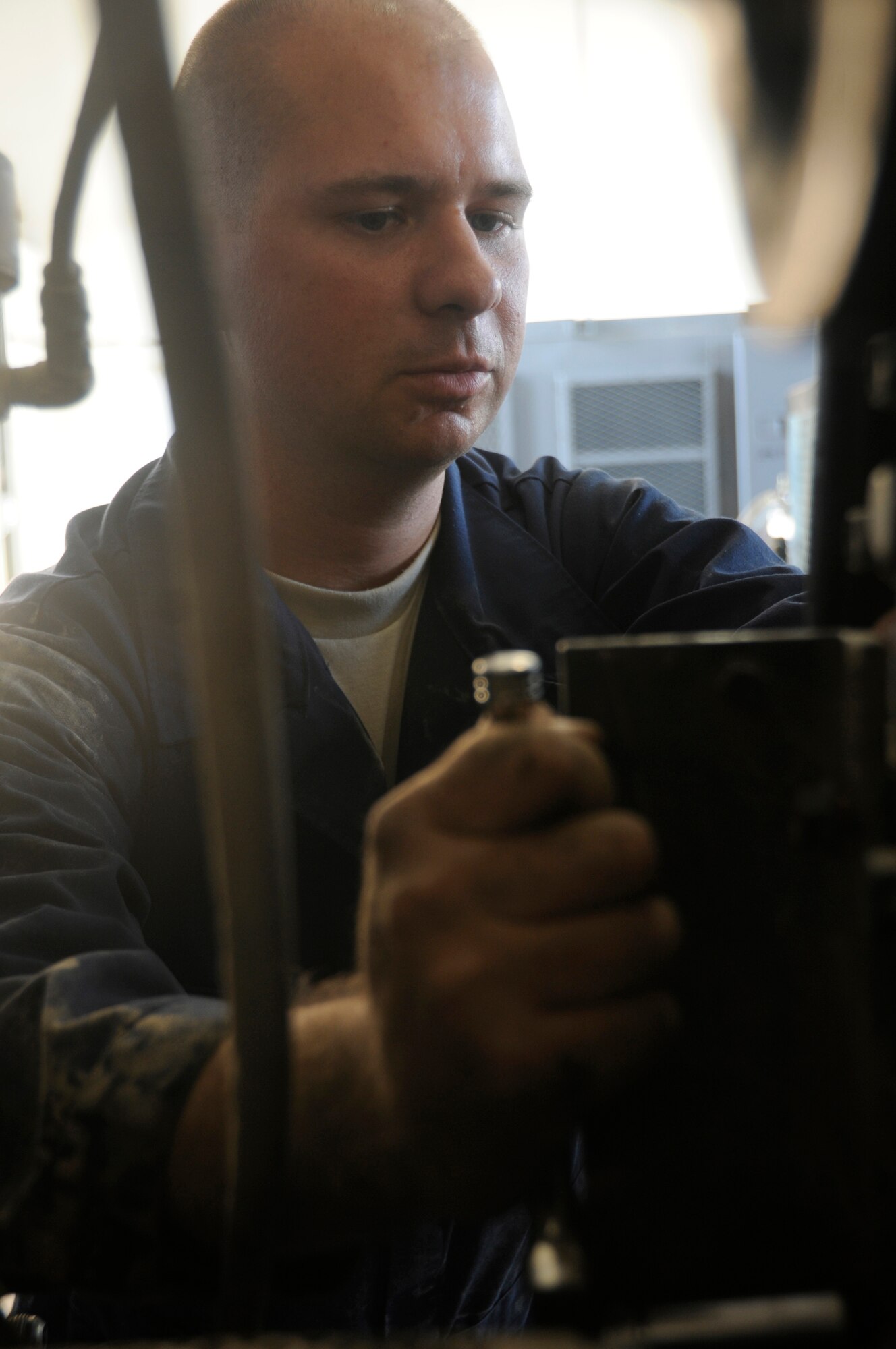 Staff Sgt. William Craddock, aerospace ground equipment craftsman assigned to the 379th Expeditionary Maintenance Squadron, installs a cannon plug assembly on a diesel-powered generator Oct. 30, at an undisclosed air base in Southwest Asia.  Sergeant Craddock, a native of Fairbanks, Alaska, is deployed from Ellsworth Air Force Base, S.D in support of Operations Iraqi and Enduring Freedom and Joint Task Force-Horn of Africa. (U.S. Air Force photo by Staff Sgt. Darnell T. Cannady/Released)