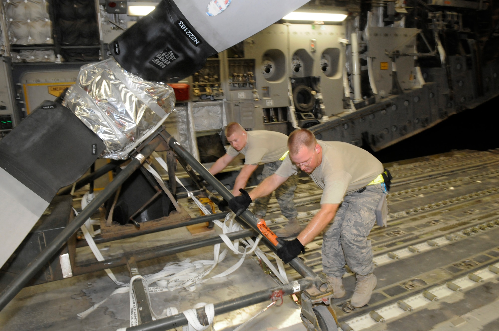 Staff Sgt. Daniel Carter and Senior Airman Joseph Daigneault, air transportation craftsmen assigned to the 8th Expeditionary Air Mobility Squadron, load a C-130 Hercules propeller into a C-17 Globemaster III, October 29, at an undisclosed air base in Southwest Asia.  The C-17 is capable of rapid strategic delivery of troops and all types of cargo to main operating bases or directly to forward bases in the Central Command area of responsibility.  Sergeant Carter hails from Elgin, Ill., and is deployed from Charleston Air Force Base, S.C.  Airman Daigneault, a native Lowell, Mass., is deployed from Little Rock Air Force Base, Ark.  Both are here in support of Operations Iraqi and Enduring Freedom and Joint Task Force-Horn of Africa.  (U.S. Air Force photo by Tech. Sgt. Michael Boquette/Released)