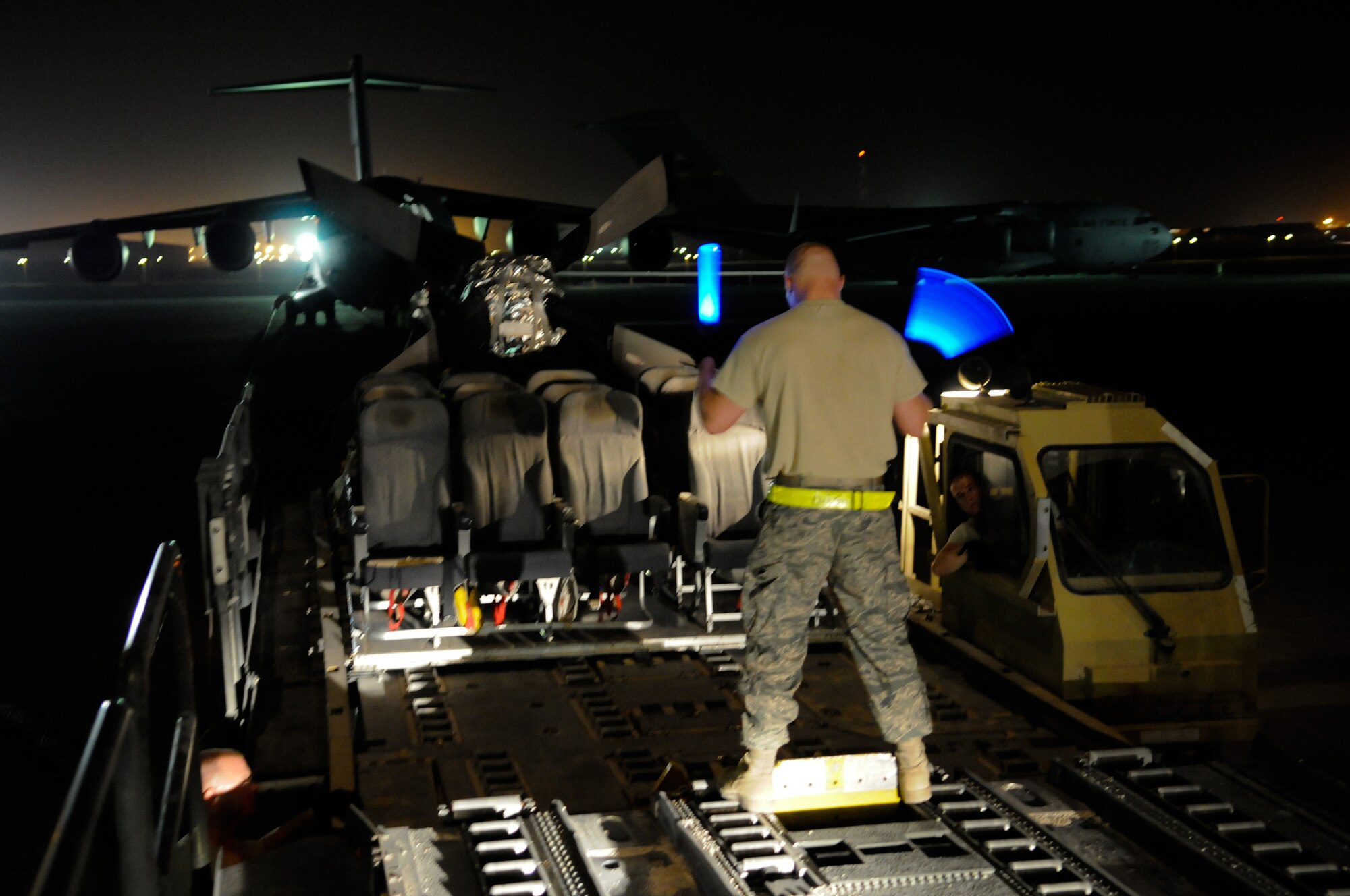 Senior Airman Joseph Daigneault, air transportation craftsman assigned to the 8th Expeditionary Air Mobility Squadron, lines up a 25K loader with a 60K loader during an upload of passenger seats and a C-130 Hercules propeller into a C-17 Globemaster III, October 29, at an undisclosed air base in Southwest Asia.  The C-17 is capable of rapid strategic delivery of troops and all types of cargo to main operating bases or directly to forward bases in the Central Command area of responsibility.  Airman Daigneault, a native Lowell, Mass., is deployed from Little Rock Air Force Base, Ark., in support of Operations Iraqi and Enduring Freedom and Joint Task Force-Horn of Africa.  (U.S. Air Force photo by Tech. Sgt. Michael Boquette/Released)