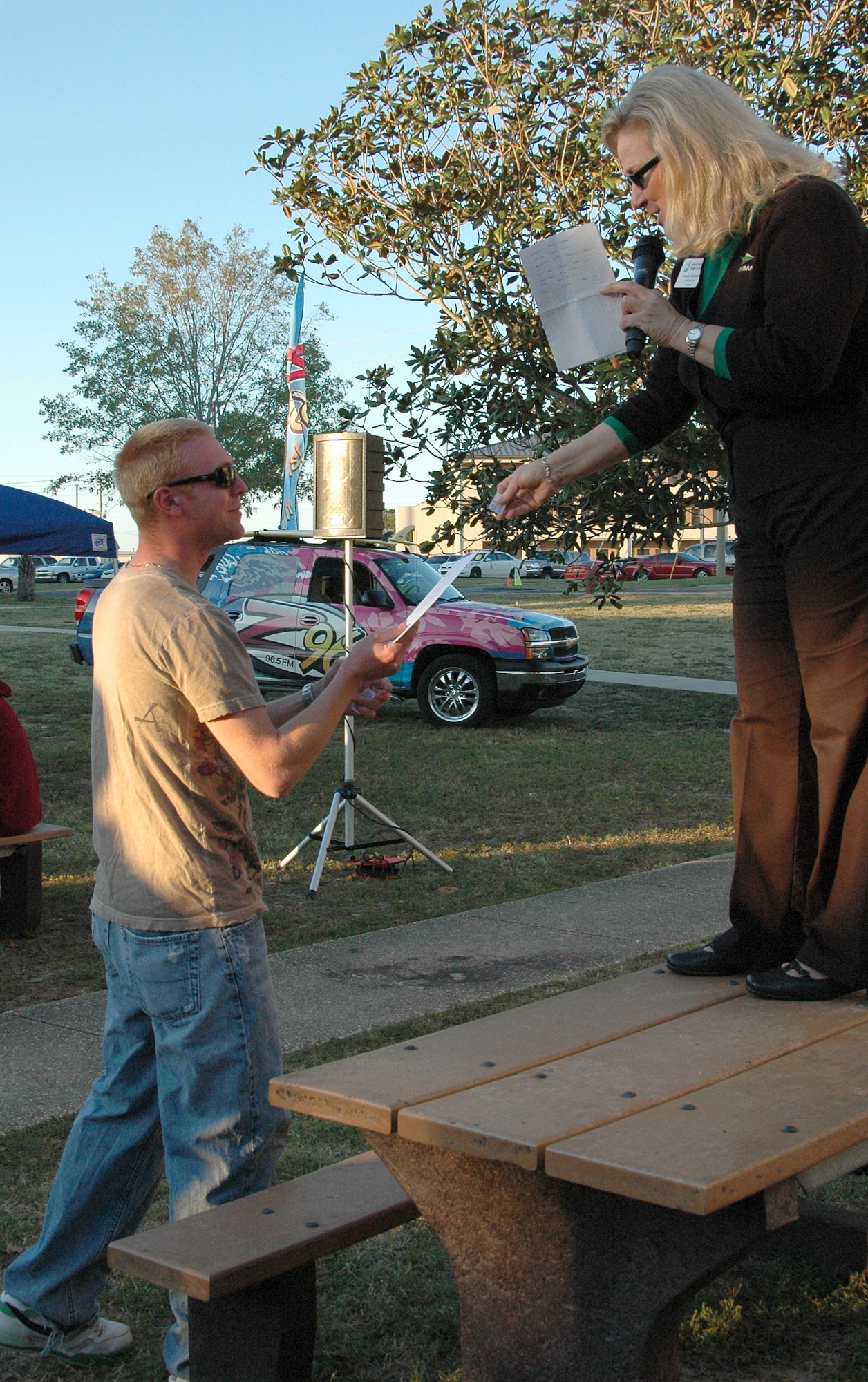 Joyce Sanders, Fort Walton Beach Chamber of Commerce life director, presents an Airman with a door prize at the ?Salute Our Troops? barbecue at the dorms on Eglin Air Force Base Oct. 29. Door prizes included a variety of items ranging from DVD players to free hotel accommodations. The barbecue, provided by the Chamber, was held for Airmen living in the dorms in recognition of their service. (U.S. Air Force Photo/Jasmine DeNamur)