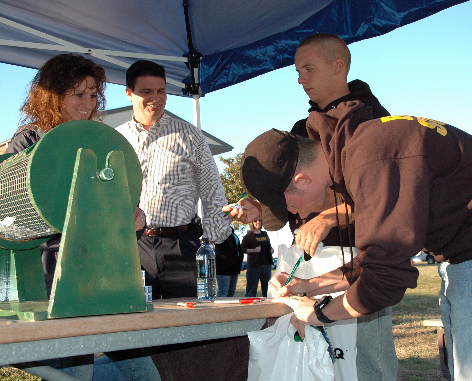 Dorm residing Airmen fill out tickets for door prizes at the ?Salute Our Troops? barbecue at the dorms on Eglin Air Force Base Oct. 29. The barbecue, provided by the Fort Walton Beach Chamber of Commerce, was held for Airmen living in the dorms in recognition of their service. (U.S. Air Force Photo/Jasmine DeNamur)