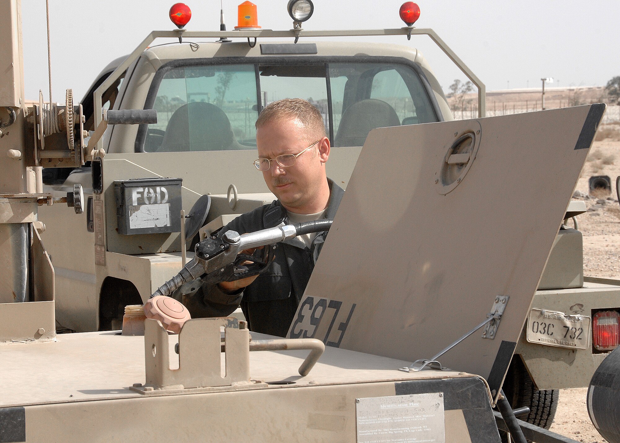 SOUTHWEST ASIA -- Tech. Sgt. William Henderson, 386th Expeditionary Maintenance Squadron Aerospace Ground Equipment flight, refuels an FL-1D portable lighting system on Oct. 28 at an air base in Southwest Asia. The AGE flight provides direct ground support for C-130 aircraft, C-17 aircraft and various transient airframes. They also perform scheduled inspections and countless unscheduled maintenance actions on their fleet of more than 200 powered and non-powered pieces of equipment. (U.S. Air Force photo/Tech. Sgt. Raheem Moore)