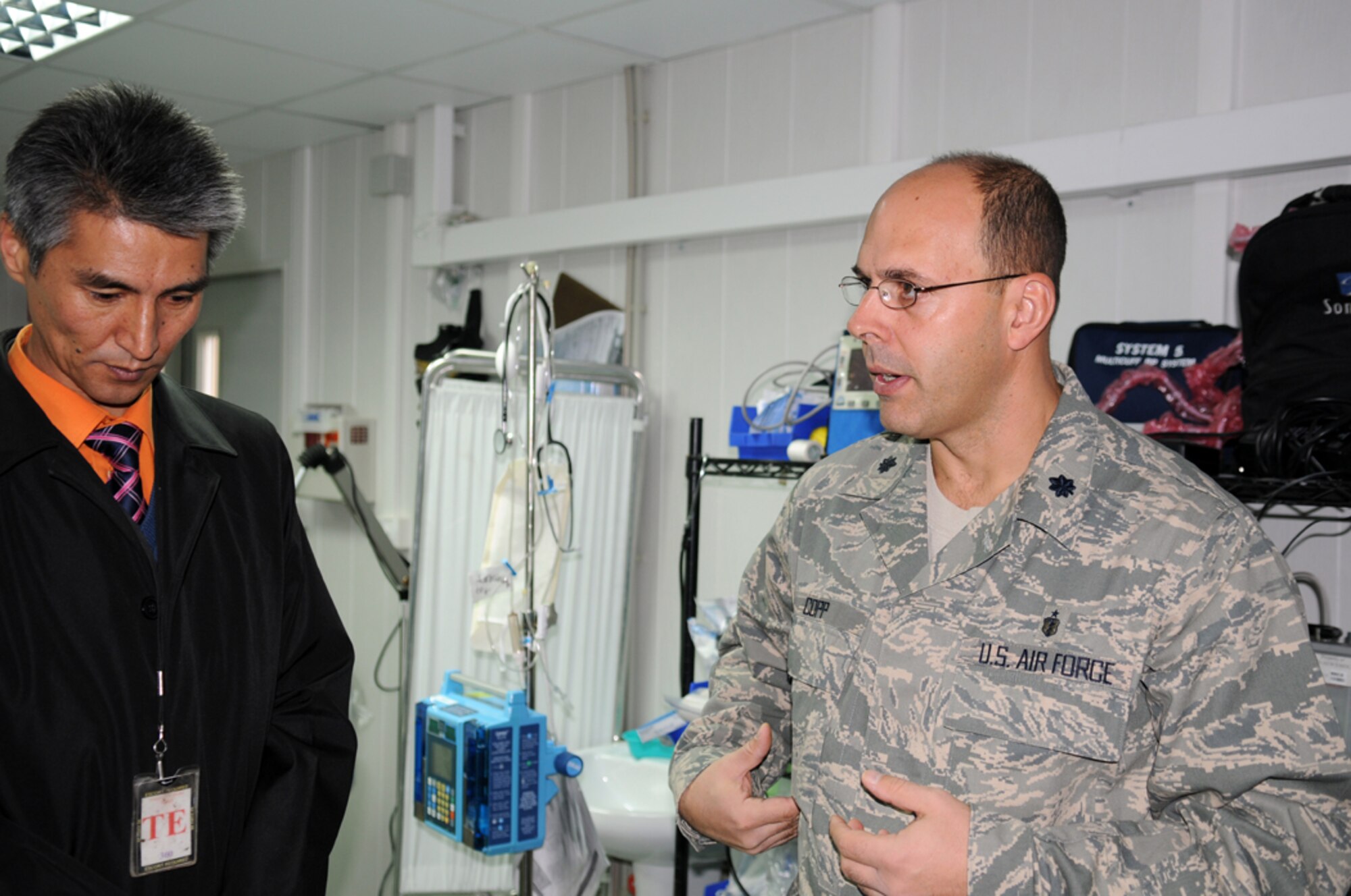 MANAS AIR BASE, KYRGYZSTAN -- Dr. Samudin Shabyraliev speaks with Lt. Col. David Copp, 376th Expeditionary Medical Group surgeon, about the capabilities of the trauma bay here, Oct. 25. The Bishkek Institute of Cardiac Surgery and Organ Transplant surgeon was invited for his first visit to the base to meet with wing leadership and tour the new medical facility. (Air Force photo / Senior Airman Ruth Holcomb)