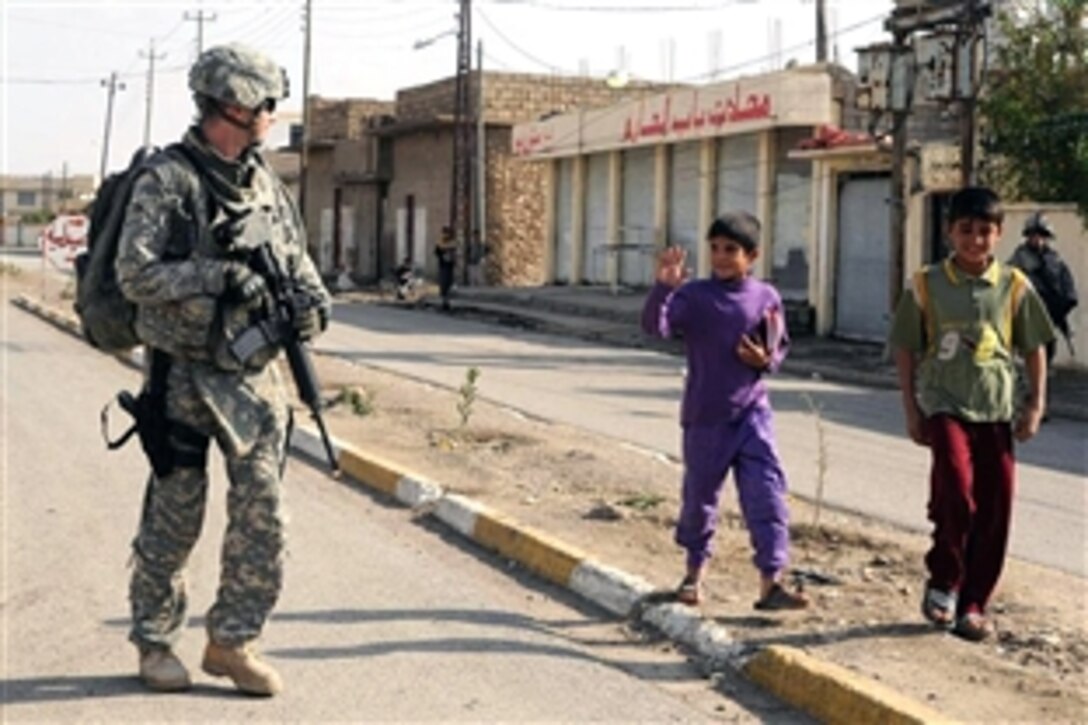 An Iraqi boy waves to U.S. Army Capt. Gavin Shwan during a patrol in Hammam Al Alill, Iraq, Oct. 27, 2008. Shwan is assigned to the 3rd Armored Cavalry Regiment's Troop G, 2nd Squadron.