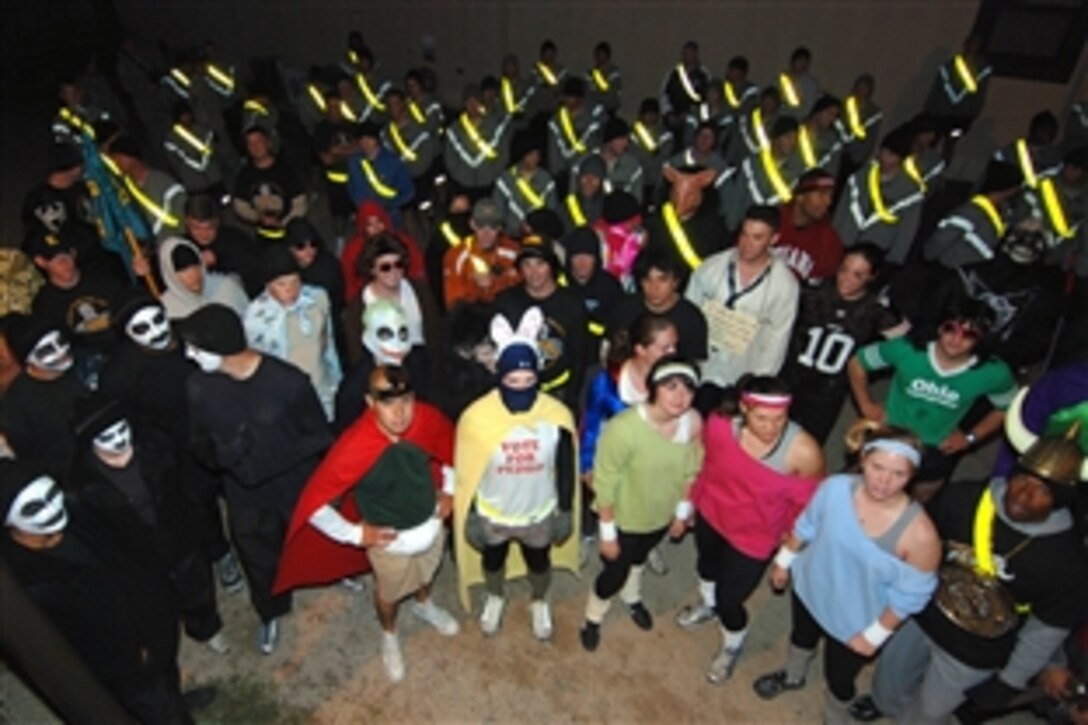 Paratroopers from Headquarters, 2nd Brigade Special Troops Battalion, 82nd Airborne Division, gather around for their weekly safety brief prior to their morning run at Fort Bragg, N.C. In the spirit of Halloween, several of the "Green Falcon" paratroopers dressed up for the Oct. 31, 2008, morning run.