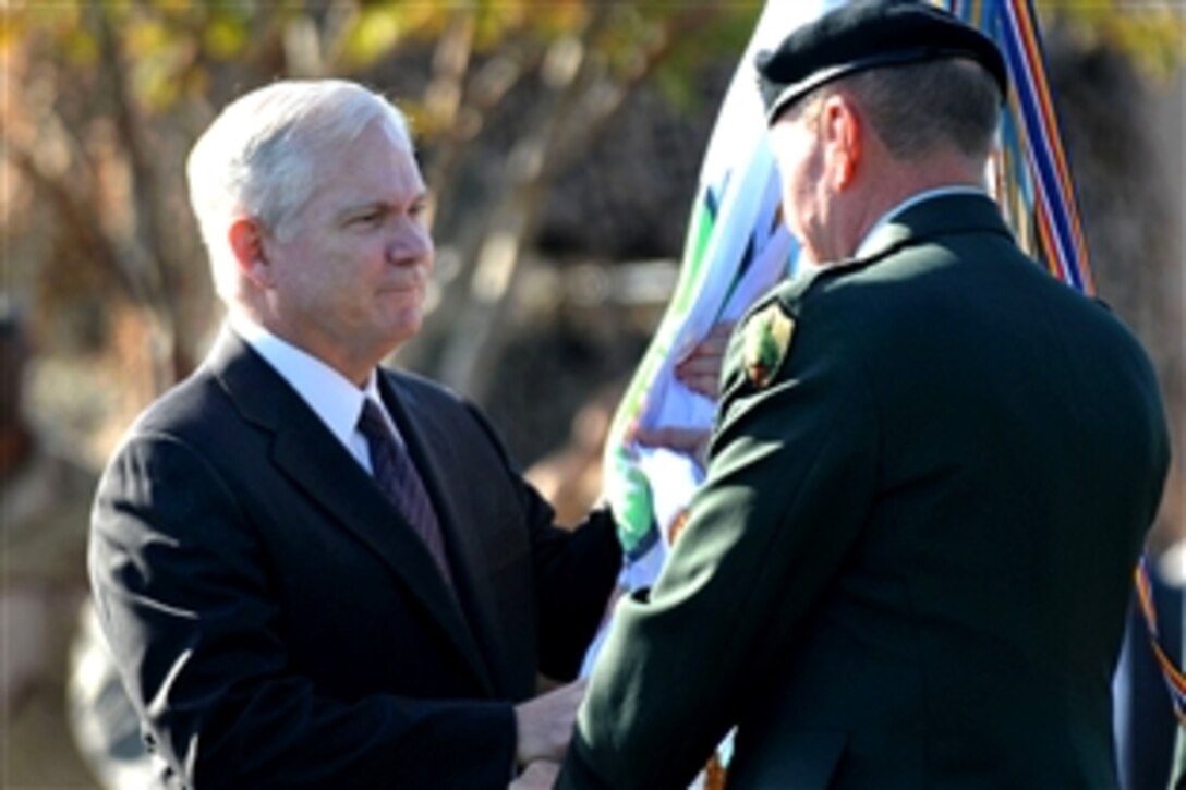 Defense Secretary Robert M. Gates presents the U.S Central Command flag to Army Gen. David H. Petraeus, who is assuming command of CENTCOM from Army Lt. Gen. Martin E. Dempsey at a ceremony on MacDill Air Force Base, Fla., Oct. 31, 2008.

