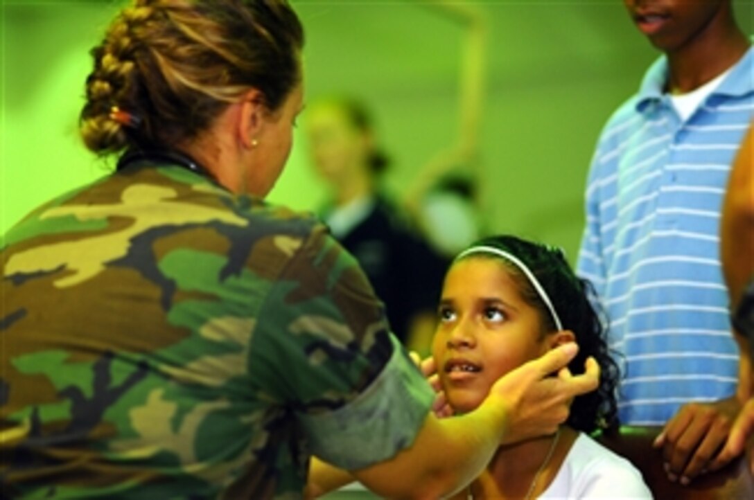 U.S. Navy Lt. Cmdr. Kathaleen Sikes, a nurse embarked aboard the amphibious assault ship USS Kearsarge (LHD 3), examines a child at the Arima District Hospital in Trinidad and Tobago on Oct. 26, 2008.  The Kearsarge is supporting the Caribbean phase of Continuing Promise 2008, an equal-partnership mission involving the United States, Canada, the Netherlands, Brazil, France, Nicaragua, Colombia, Dominican Republic, Trinidad and Tobago and Guyana.  
