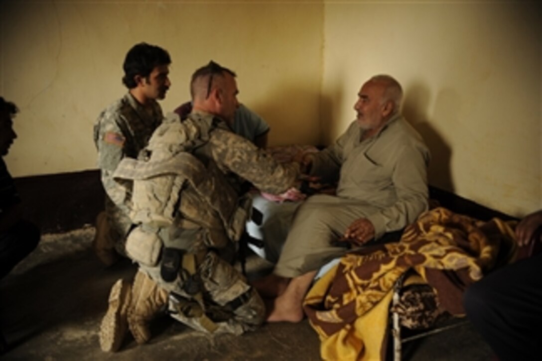 U.S. Army Sgt. William Allen, a medic from 2nd Squadron, 3rd Armored Cavalry Regiment, examines an Iraqi man during a reconnaissance patrol in Hammam Al Alill, Iraq, on Oct. 28, 2008.  