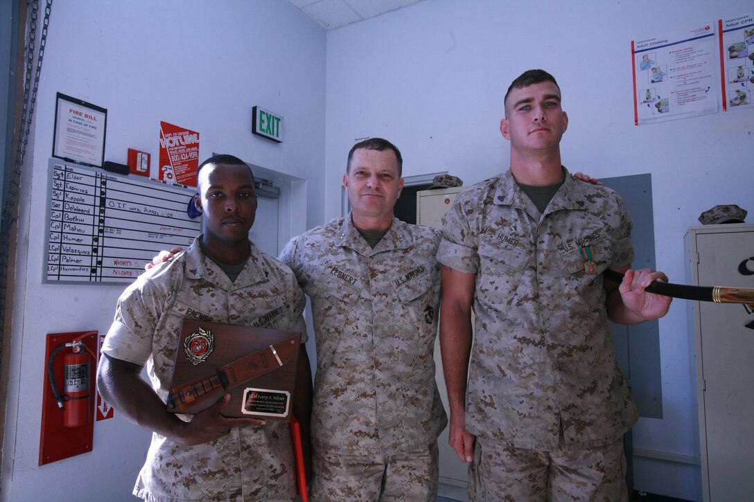 Cpl. Eric A. Humer, navigational technician, from Dover, Pa., and Lance Cpl. Larry R. Palmer, communications technician, from Birmingham, Ala., both with Marine Corps Air Station Camp Pendleton, Headquarters and Headquarters Squadron, stand next to Maj. Gen. Michael R. Lehnert, commanding general, Marine Corps Installations West, Oct 31. Humer and Palmer were awarded noncommissioned officer and Marine of the quarter awards for the fourth quarter fiscal year 2008, the Navy Achievement Medal and a challenge coin from Lehnert.