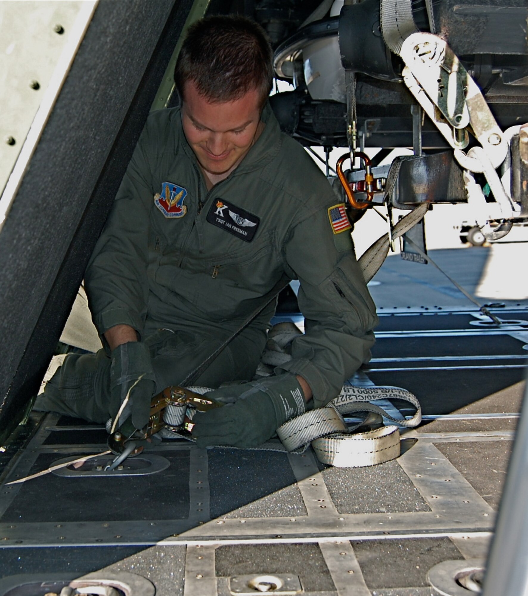 Tech. Sgt. Ian Freeman, a loadmaster with the 129th Rescue Wing, secures cargo on the deploying MC-130P Combat Shadow tanker  Sep. 1, 2008.  The 129th brought equipment including trucks, jet skis and boats for the deploying pararescue personnel to have on hand in preparation of the aftermath of Hurricane Gustav. (U.S. Air Force photo by Staff Sgt. Jill Jamgochian)