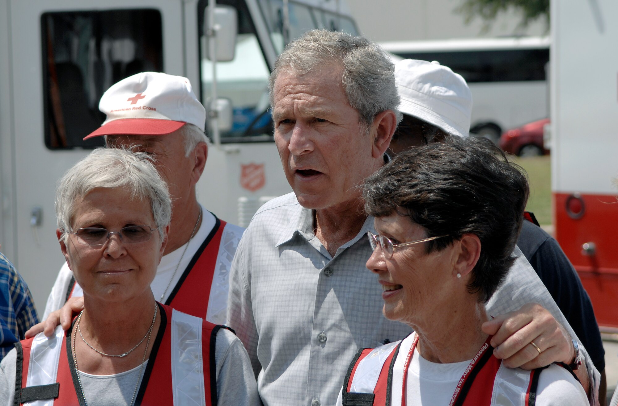 President George W. Bush stands with volunteers from the Salvation Army as he conducts a live interview about relief efforts of Hurricane Gustav at Port San Antonio, Texas Sept. 1. "My call to my fellow citizens is to find out how you can help," President Bush said. "America is a great country, and nobody is happy about this storm."  (U.S. Air Force photo/Staff Sgt. Bennie J. Davis III)