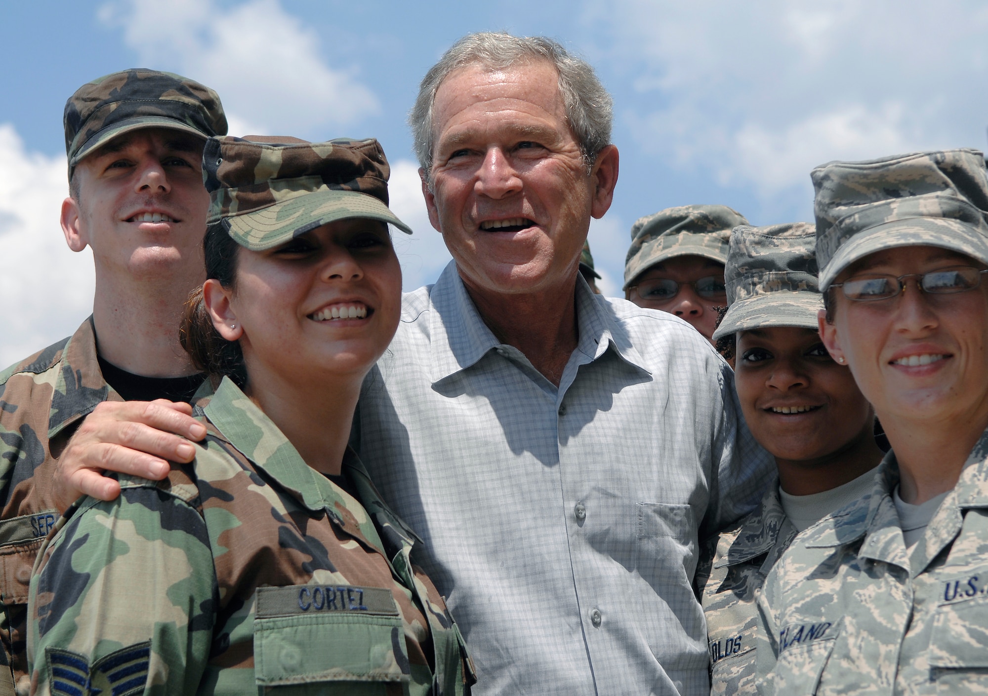 President George W. Bush poses with Airmen from the 59th Medical Wing and Texas Air National Guard 149th Fighter Wing who volunteered to help process over 700 evacuees of Hurricane Gustav at Port San Antonio Sept 1. 
(U.S. Air Force photo/Staff Sgt. Bennie J. Davis III)