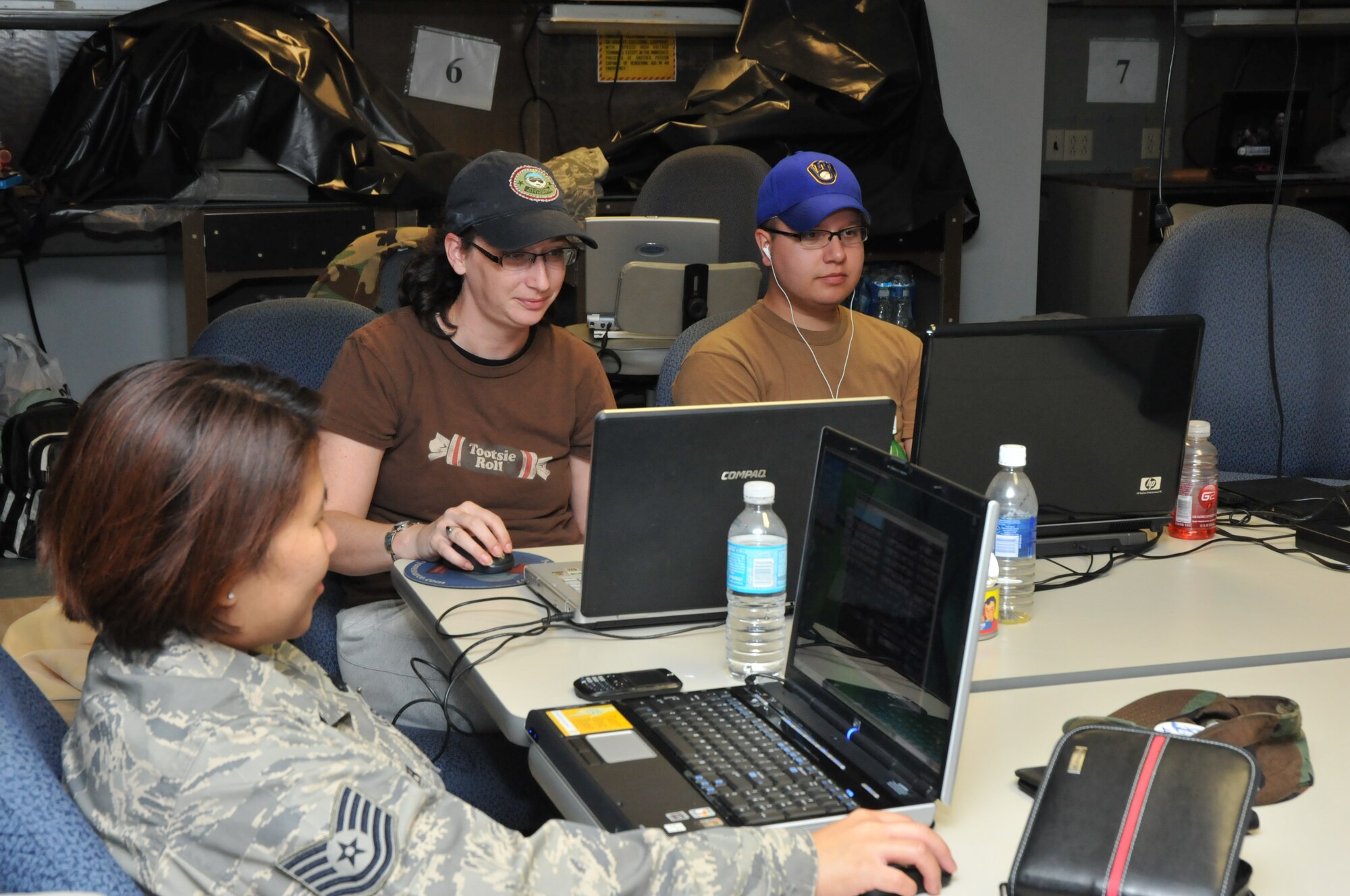 Tech. Sgt. Bernalhee McFadden, Senior Airman Faith Martin and Staff Sgt. Tory Jaeck, technical training students from the 335th Training Squadron, stay busy on their laptops during Hurricane Gustav.  Sergeants McFadden and Jaeck and Airman Martin all sheltered in Wolfe Hall, a designated hurricane shelter on Keesler (U.S. Air Force photo by Adam Bond). 