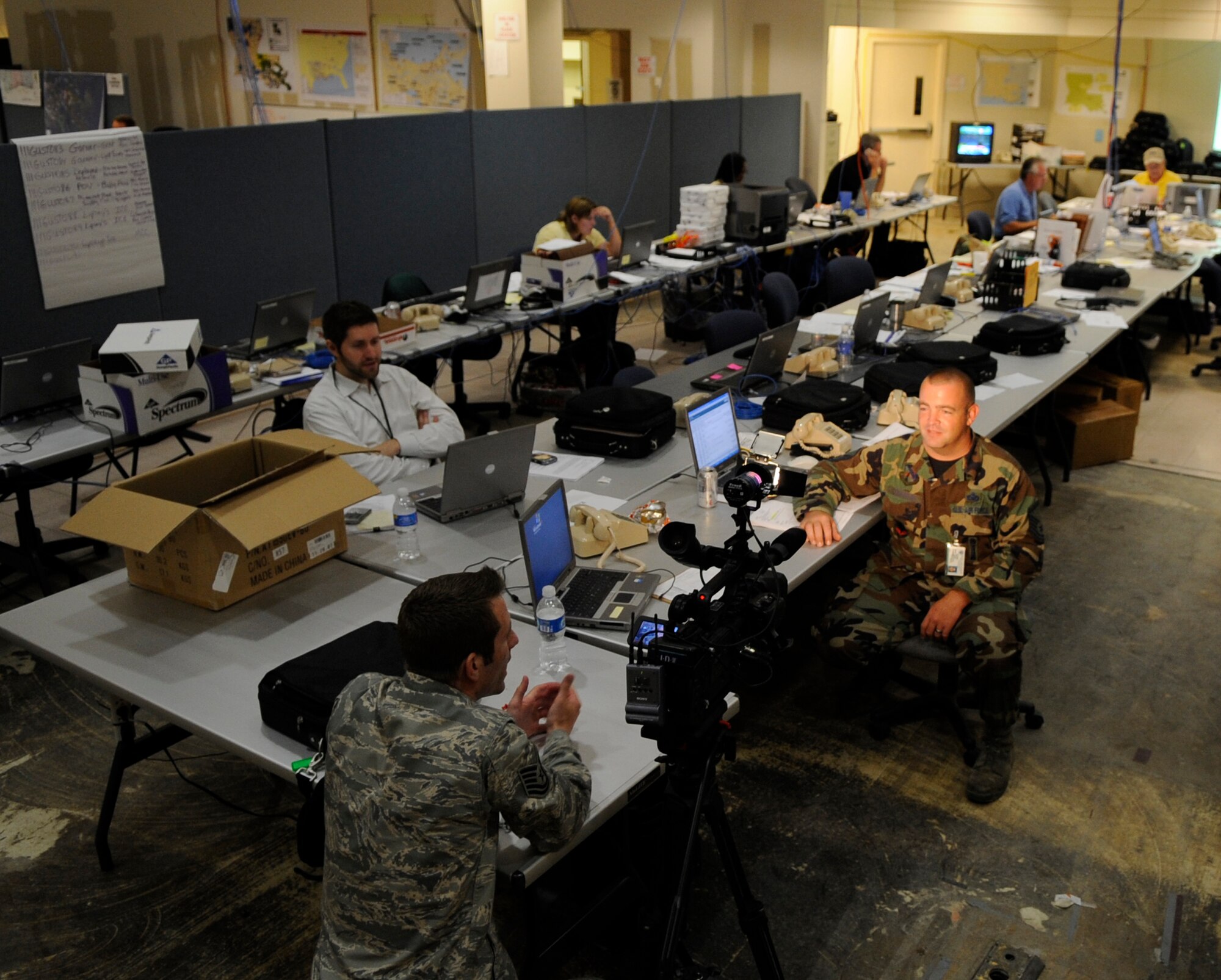 Tech. Sgt. Lee Hoover, an Air Force News Agency broadcaster, interviews Master Sgt. Glenn Coughlin Sept. 1 at the Hurricane Gustav Joint Field Office in Baton Rouge, La.  Sergeant Coughlin, with the Louisiana Air National Guard’s 159th Fighter Wing at Naval Air Station Joint Reserve Base-New Orleans just north of New Orleans, is a logistics supply specialist assigned to assist Federal Emergency Management Agency officials during evacuation and relief efforts.    (U.S. Air Force photo/Staff Sgt. Shawn Weismiller)
