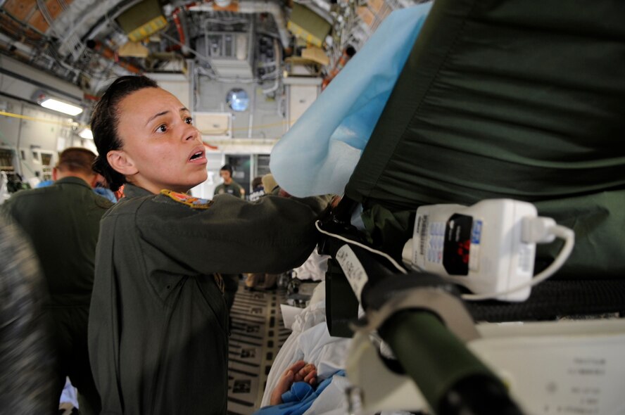 Senior Master Sgt. Frances Williams helps an evacuee of Hurricane Gustav board a flight Aug. 31 at Lake Front Airport, New Orleans, La.  The Federal Emergency Management Agency and the Department of Defense chartered flights to transport citizens to destinations safely outside the hurricane's path. (U.S. Air Force photo by Staff Sgt. Shawn Weismiller)