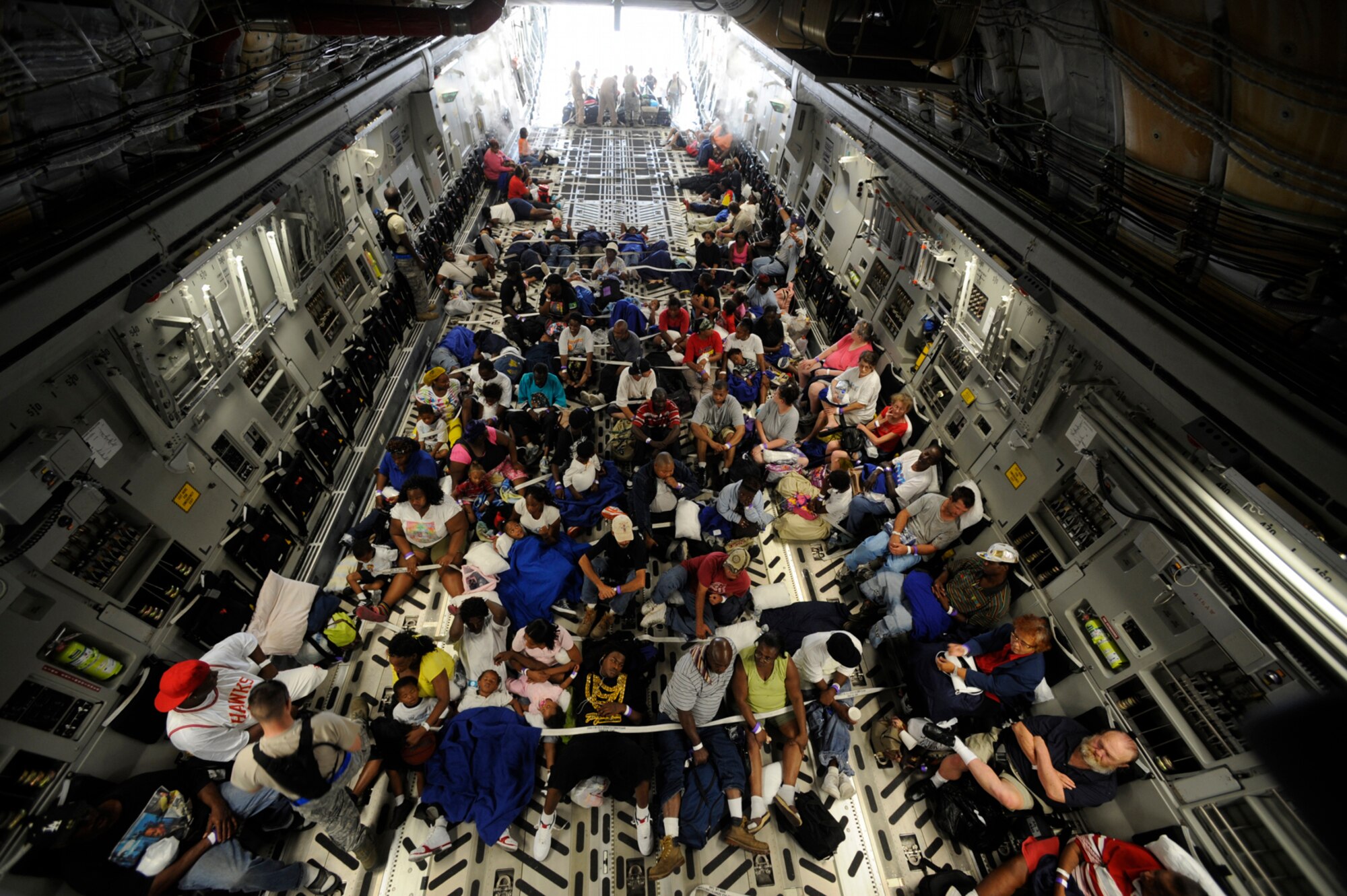 Evacuees of Hurricane Gustav board a C-17 Globemaster III at the Louis Armstrong International Airport, New Orleans, La., Aug. 31. The Federal Emergency Management Agency and The Department of Defense chartered flights to transport citizens to destinations safely outside the hurricane's path. (U.S. Air Force photo by Staff Sgt. Shawn Weismiller)