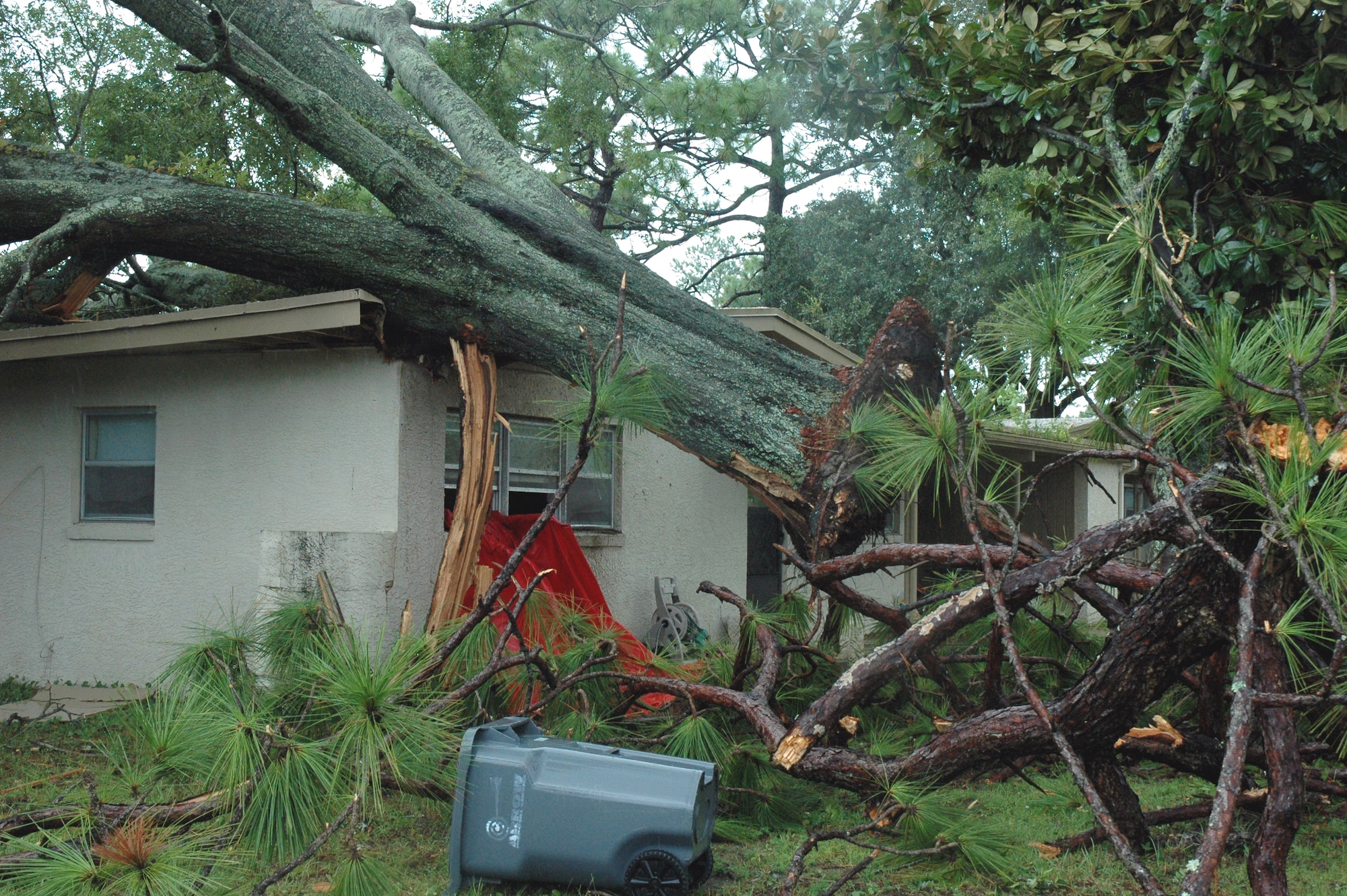 An uprooted tree rests on the home of Airman 1st Class Devin Hennessy, 46th Operations Support Squadron, after a tornado touched down in Eglin's housing area Sept. 1.  (U.S. Air Force photo by Tech. Sgt. Brian Jones)