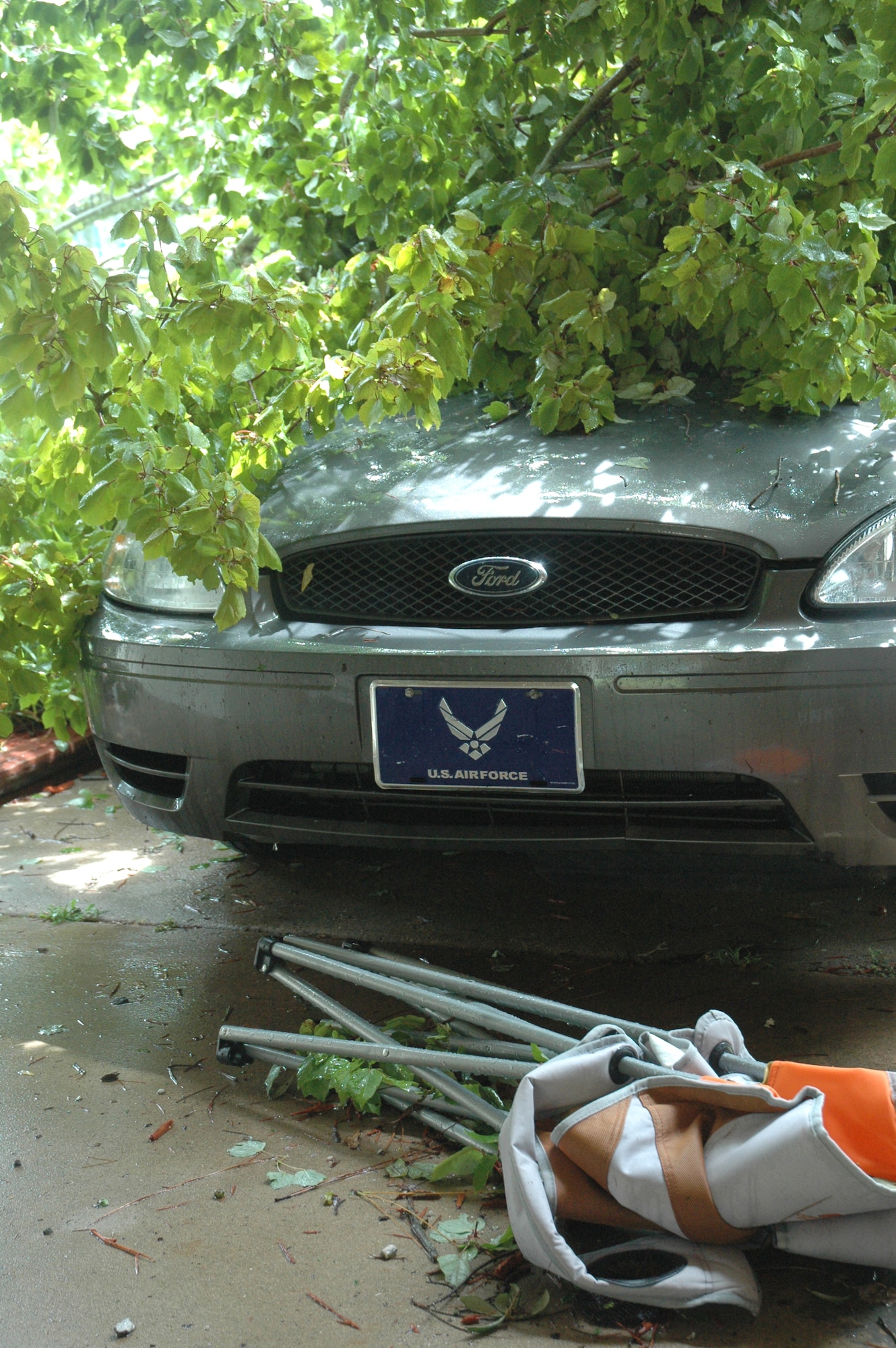 A tree covers Airman 1st Class Caleb Sikes' car after a tornado touched down in Eglin's base housing Sept. 1. (U.S. Air Force photo by Tech. Sgt. Brian Jones)