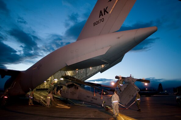 KULIS AIR NATIONAL GUARD BASE, Alaska -- In the early morning hours of Sept. 1, 2008, Alaska Air National Guardsmen from the 176th Logistics Readiness Squadron maneuver an HH-60 Pave Hawk helicopter onto the loading ramp of a C-17 strategic airlift jet. The helicopter is one of two the Alaska Air National Guard?s 176th Wing is deploying to the Gulf Coast region to support possible search-and-rescue operations expected in the wake of Hurricane Gustav. Approximately 30 wing members have deployed to the region as well. Alaska Air National Guard photo by Lt Col Tim O'Brien.