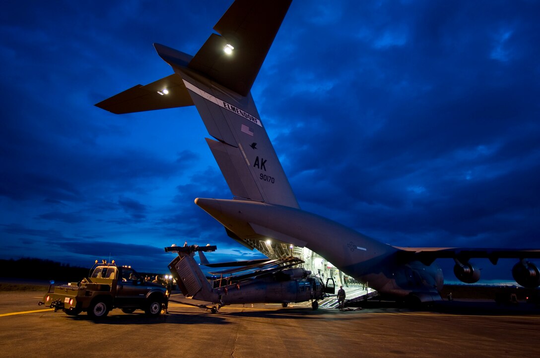 KULIS AIR NATIONAL GUARD BASE, Alaska -- In the early morning hours of Sept. 1, 2008, Alaska Air National Guardsmen from the 176th Logistics Readiness Squadron maneuver an HH-60 Pave Hawk helicopter onto the loading ramp of a C-17 strategic airlift jet. The helicopter is one of two the Alaska Air National Guard?s 176th Wing is deploying to the Gulf Coast region to support possible search-and-rescue operations expected in the wake of Hurricane Gustav. Approximately 30 wing members have deployed to the region as well. Alaska Air National Guard photo by Lt Col Tim O'Brien.