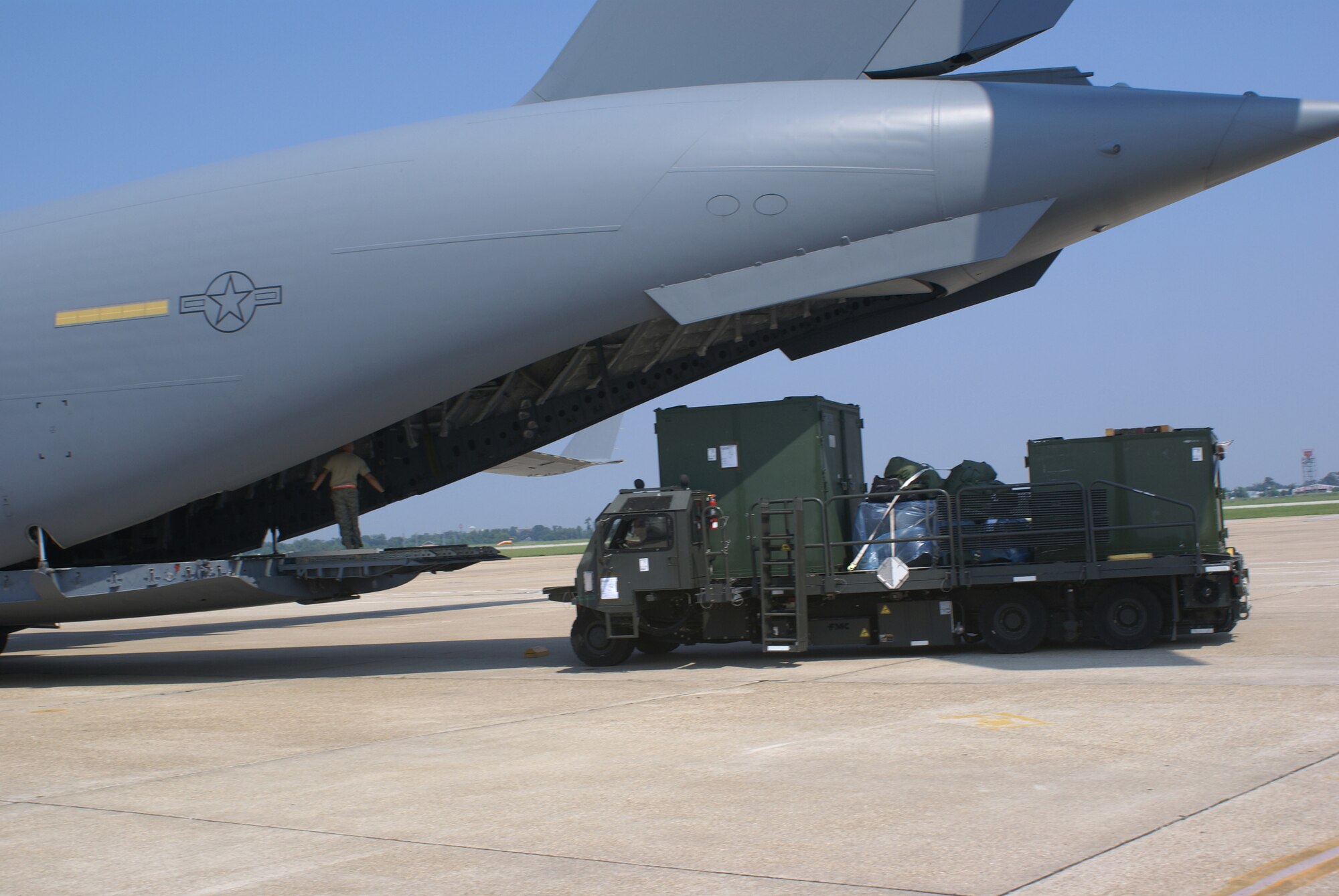 Airmen with the 615th Contingency Response Wing's aerial port flight from Travis Air Force Base, Calif., unload cargo from a C-17 Globemaster III Aug. 30 at the Louis Armstrong International Airport in New Orleans.  The aircrew, from McChord AFB, Wash., delivered the contingency response team and 15,500 lbs of cargo to New Orleans in preparation for Hurricane Gustav. (U.S. Air Force photo/Staff Sgt. Oshawn Jefferson)                   