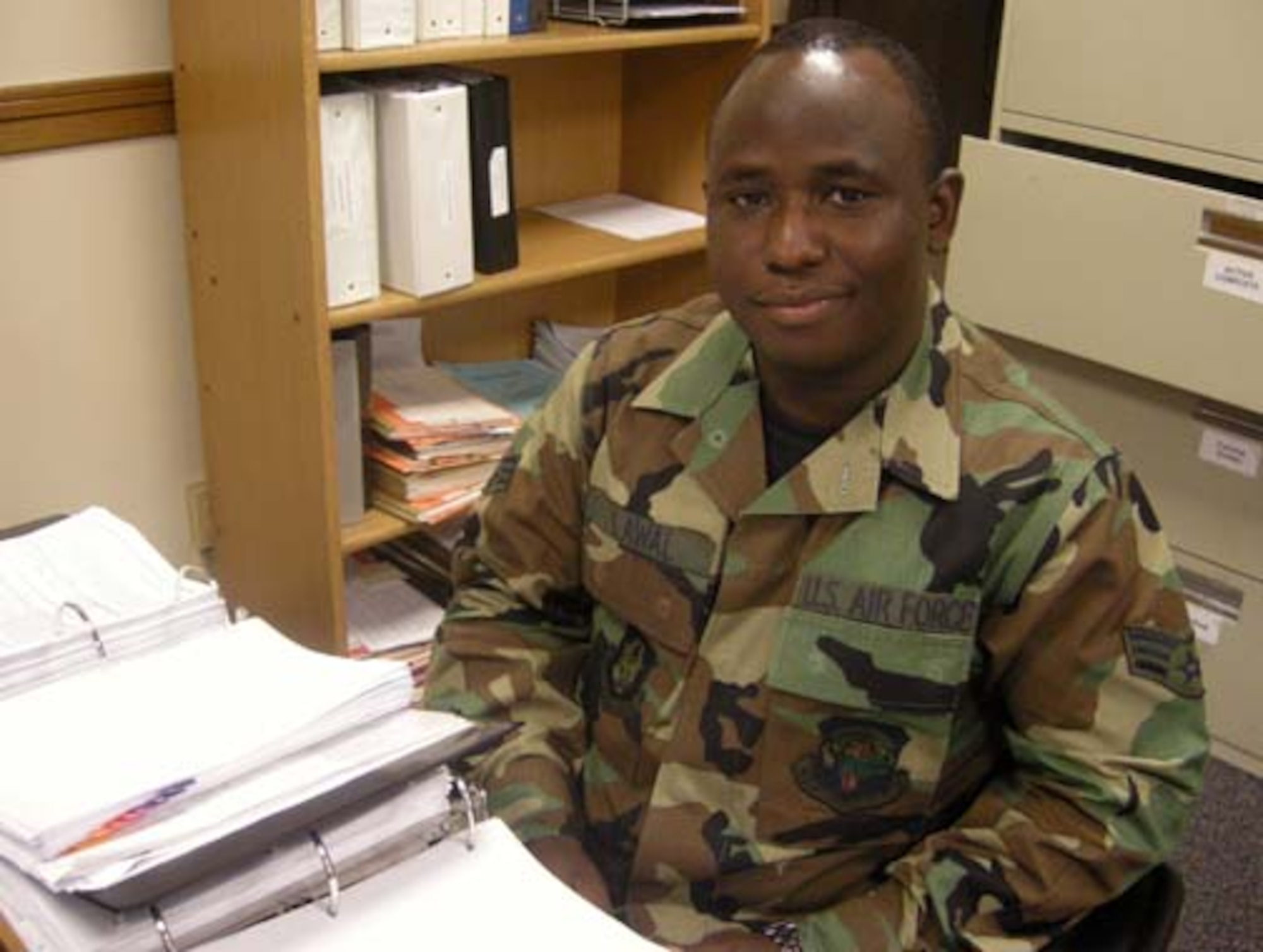 ANDREWS AIR FORCE BASE, Md. -- Airman 1st Class Kayode Lawal, 459th Mission Support Flight personnel relocations clerk, pauses during records review here Aug. 20. The Nigerian-born Airman obtained U.S. citizenship Aug. 6. (U.S. Air Force photo/Tech. Sgt. Amaani Lyle)
