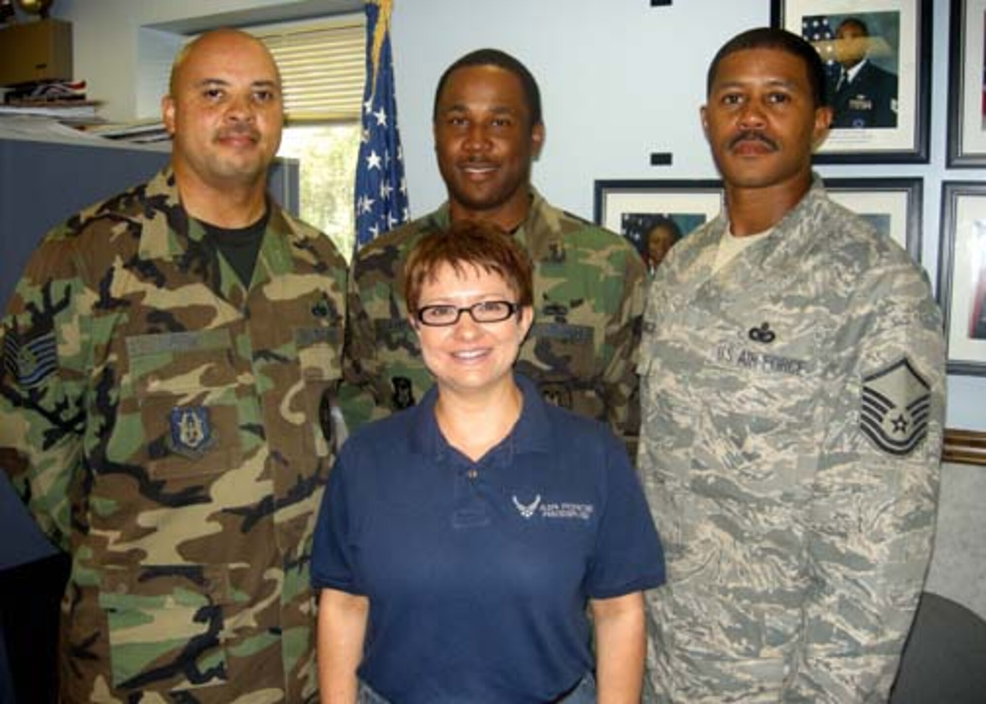 ANDREWS AIR FORCE BASE, Md. -- Part of the Team Andrews Recruiters, Tech. Sgt. Anthony Cave, Master Sgt. Jessie Boyer, Master Sgt. Darryl Washington and (front) Master Sgt. Jeanette Masters, 459th Air Refueling Wing health professions recruiter, pause for a smile Aug. 20. (U.S. Air Force photo/Tech. Sgt. Amaani Lyle)