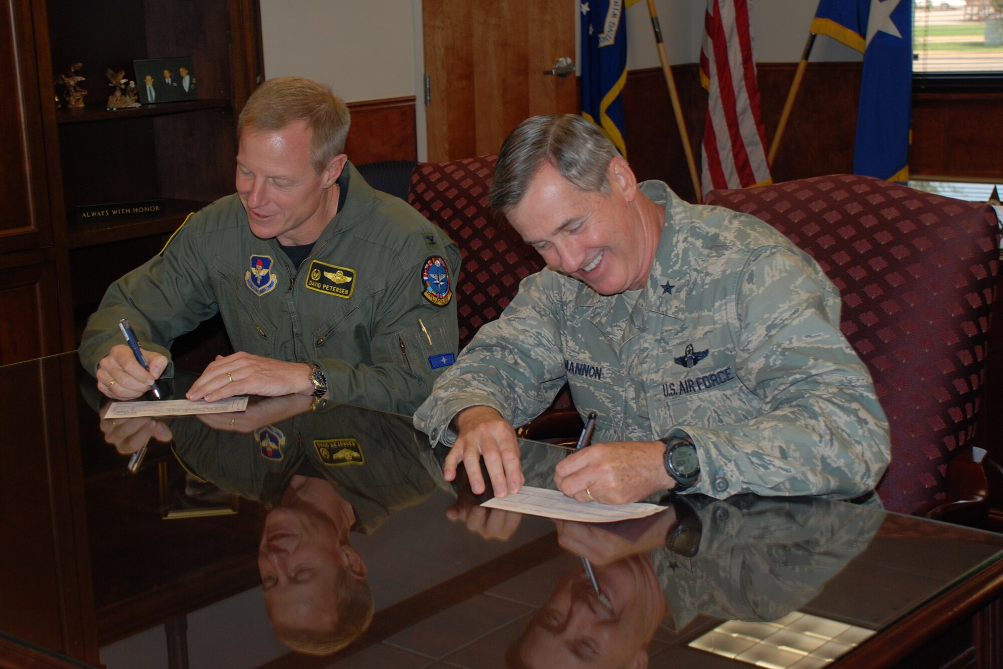 Brig. Gen. O.G. Mannon, 82nd Training Wing commander, and Col. David Petersen, 80th Flying Training Wing commander, fill out their Combined Federal Campaign fund forms Aug. 29. Sheppard's fundraising cycle began Sept. 2 and will continue through Oct. 15. (U.S. Air Force photo/Airman 1st Class Candy Miller)