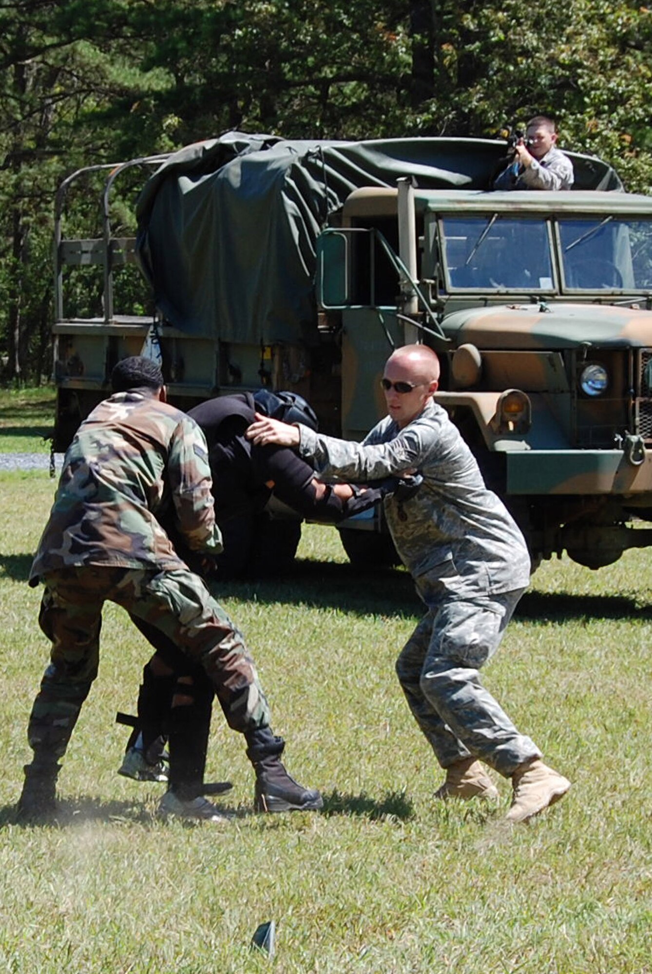 Students in the U.S. Air Force Expeditionary Center's Phoenix Raven Training Course battle an "agressor" during an evaluation session for the Raven course on a Fort Dix, N.J., range Aug. 20, 2008.  Raven training is taught by the Center's 421st Combat Training Squadron at Fort Dix.  It gives security forces Airmen specialized training in aircraft security, verbal judo and self defense.  (U.S. Air Force Photo/Tech. Sgt. Scott T. Sturkol)