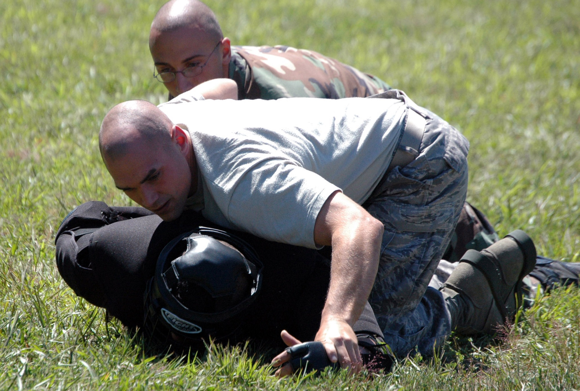 Students in the Air Force Phoenix Raven Training Course restrain an "aggressor" during an evaluation session in the course on a Fort Dix, N.J., range Aug. 20, 2008.  The course, taught by the U.S. Air Force Expeditionary Center's 421st Combat Training Squadron, trains security forces Airmen to become Ravens where they specialize in protecting Air Force aircraft in austere environments.  (U.S. Air Force Photo/Tech. Sgt. Scott T. Sturkol)