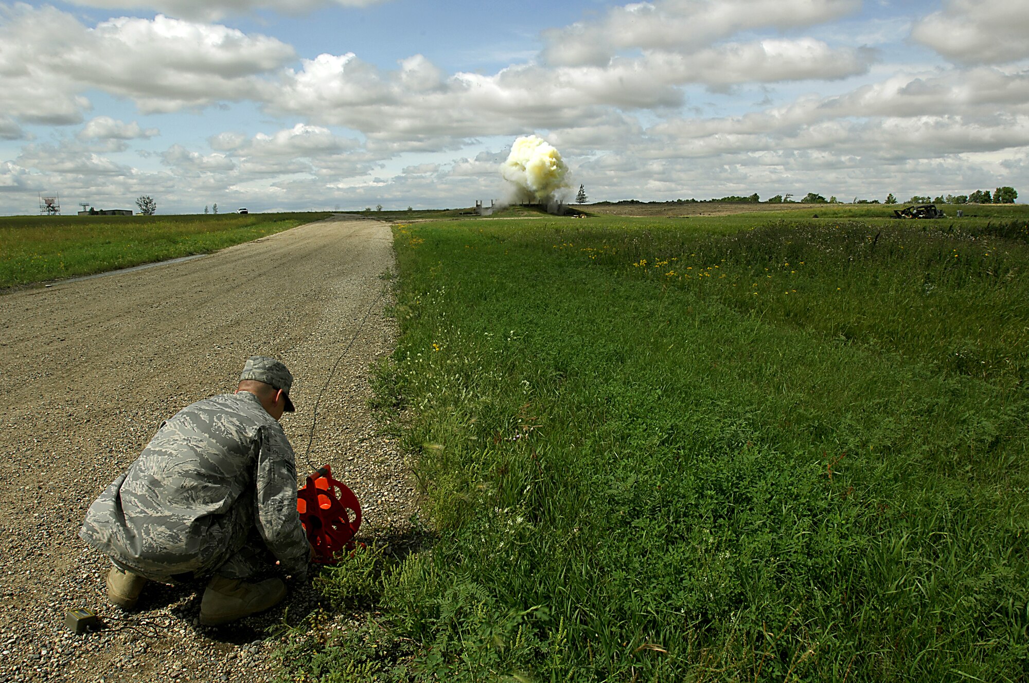 MINOT AIR FORCE BASE, N.D. — Senior Airman Kyle McGann, 5th Civil Engineer Squadron explosive ordnance disposal support apprentice, detonates a composition C-4 plastic explosive during an EOD training exercise here Aug. 22. EOD conduct these exercises as part of their monthly training regimen. (U.S. Air Force photo by Airman 1st Class Jesse Lopez)