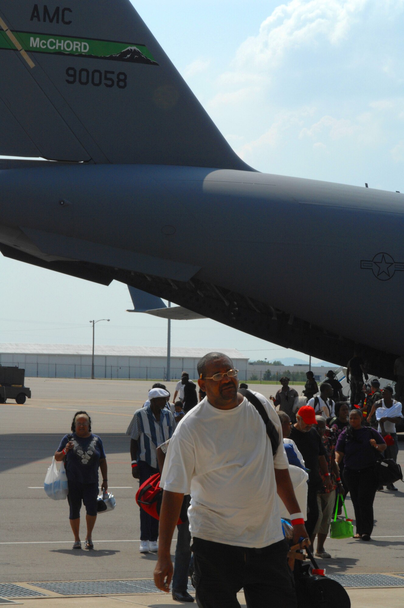 Hurricane Gustav evacuees from New Orleans step off a C-17 Globemaster III from McChord Air Force Base, Wash., Aug. 31 after being transported out of harm's way. To date, Air Mobility Command units have transported more than 6,500 Gustav evacuees to safety. The evacuees were sent to various locations throughout the United States, where relief teams were waiting with food, water and shelter. (U.S. Air Force photo/Senior Airman Jennifer Romig)