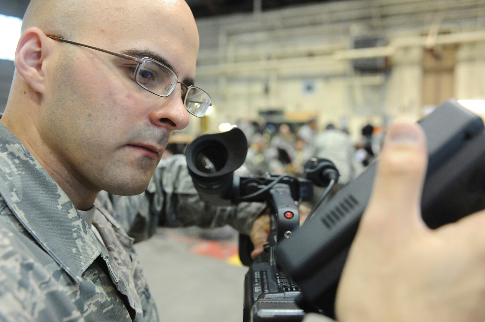 Senior Airman James Stewart, 354th Fighter Wing Public Affairs broadcaster, sets up his camera and gear prior to the Presidential visit Aug. 4, 2008, in the Thunderdome. Airman Stewart is one of three broadcasters on Eielson, whose job it is to capture the Iceman Team's mission and unveil it to a visual audience through broadcast news stories. (U.S. Air Force photo by Airman 1st Class Jonathan Snyder)