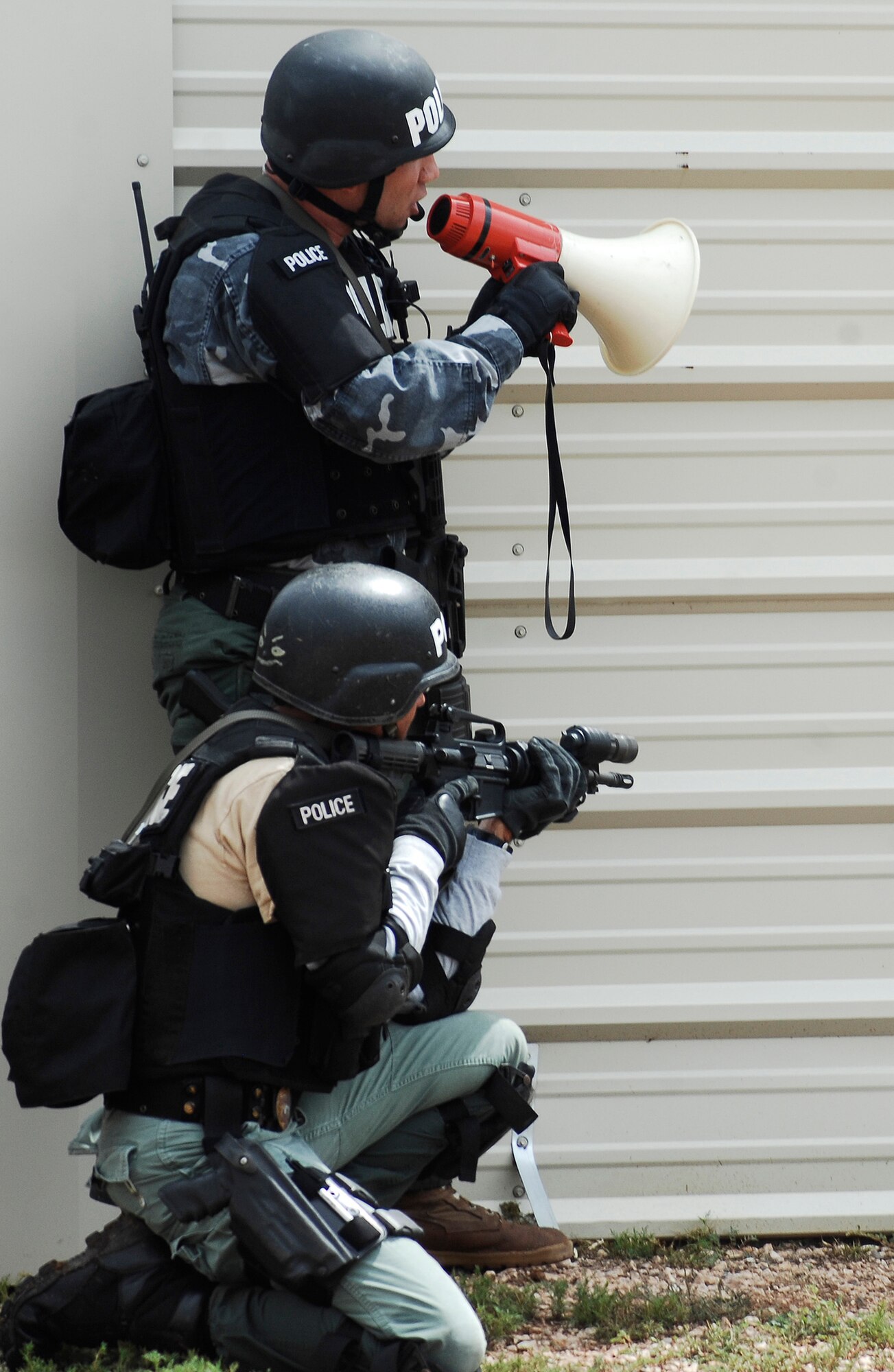 CANNON AIR FORCE BASE, N.M. -- Members from the Clovis Police Department work to secure a building during an exercise Aug. 27.  The exercise was an evaluation of Cannon's response to a domestic terrorism event. According to Maj. Ken Mershon, 27th Special Operations Wing Inspector General deputy, the base reacted extremely well to the exercise inputs presented by the IG staff. (U.S. Air Force photo/Senior Airman Liliana Moreno) 