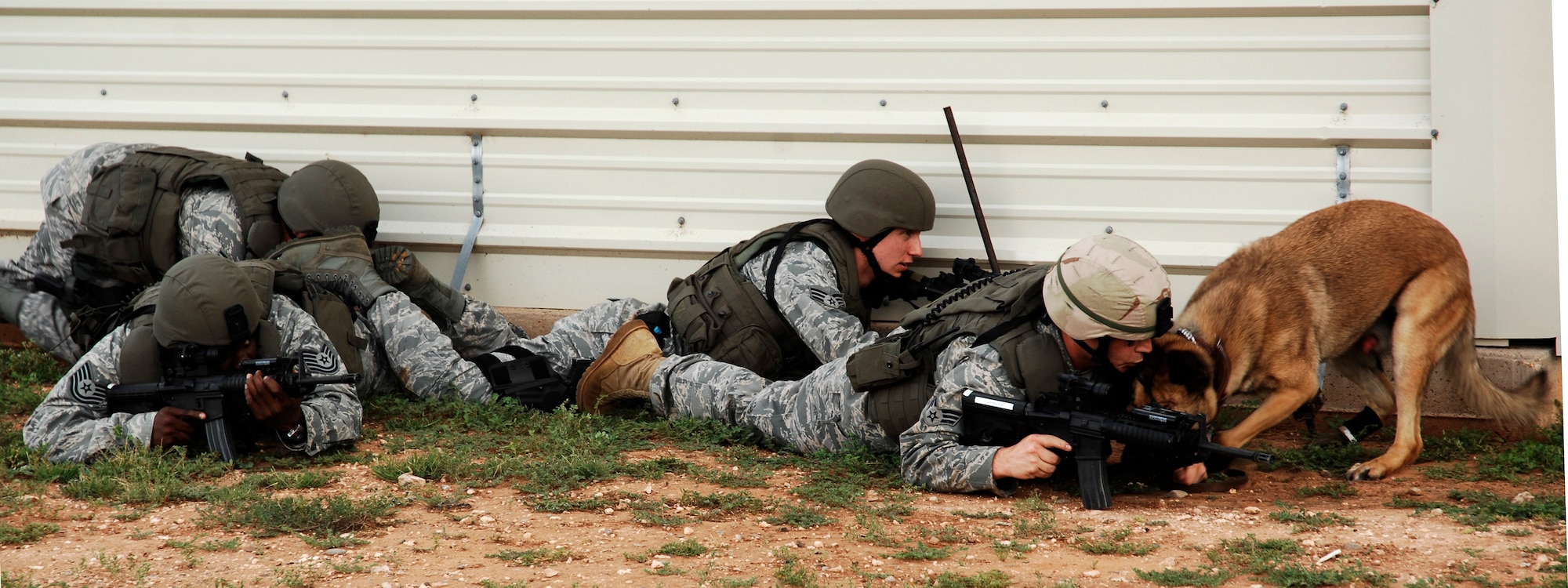 CANNON AIR FORCE BASE, N.M. -- Airmen from the 27th Special Operations Security Forces Squadron take cover during a simulated small arms fire, Aug. 27. The exercise was an evaluation of Cannon's response to a domestic terrorism event. During an exercise like this, according to Maj. Ken Mershon, 27th Special Operations Wing Inspector General deputy, all personnel should consider their individual roles and the critical importance of the task at hand because they're part of a bigger objective: maintaining operational effectiveness. (U.S. Air Force photo/Senior Airman Liliana Moreno) 